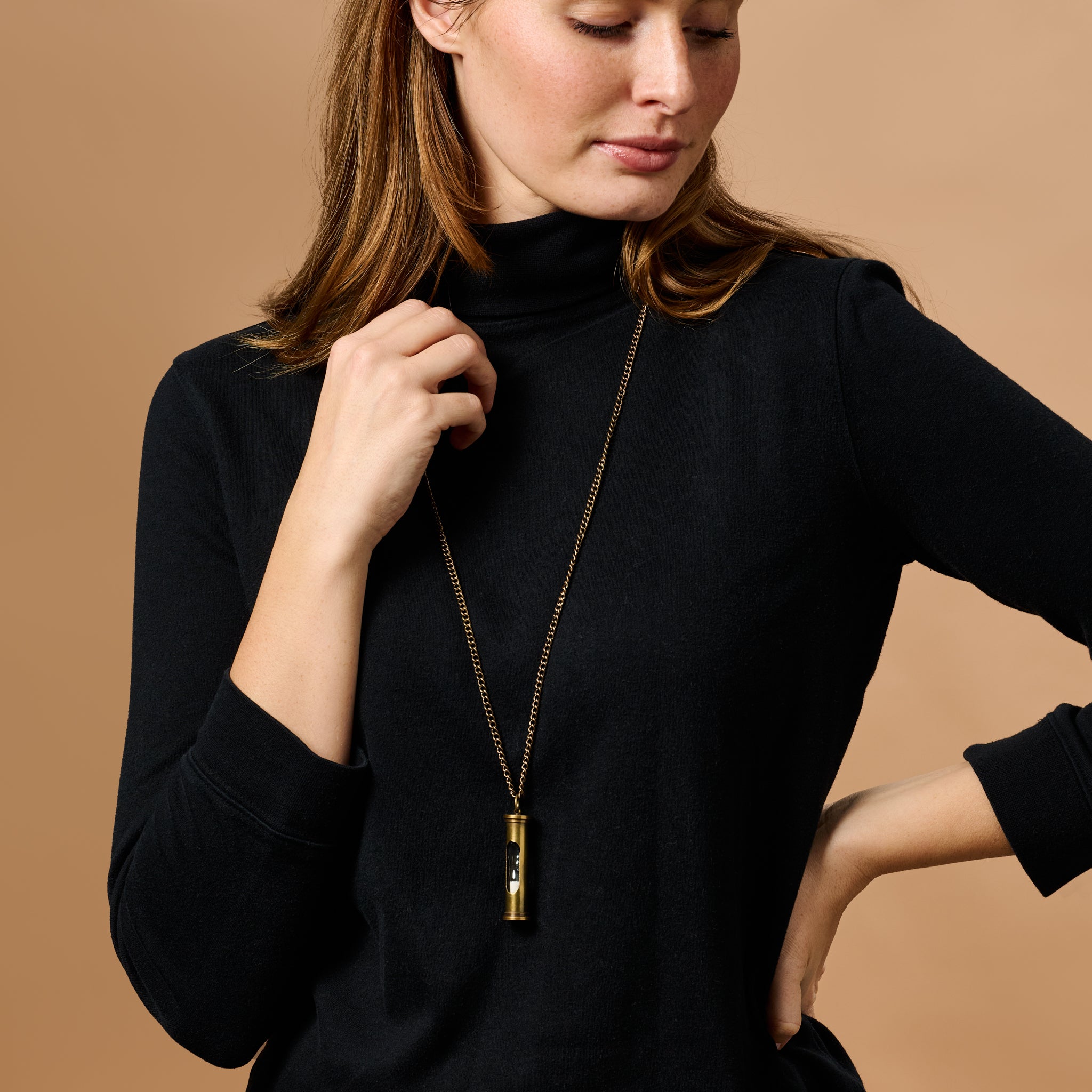 Close-up of the handcrafted hourglass pendant necklace highlighting its intricate design and craftsmanship.