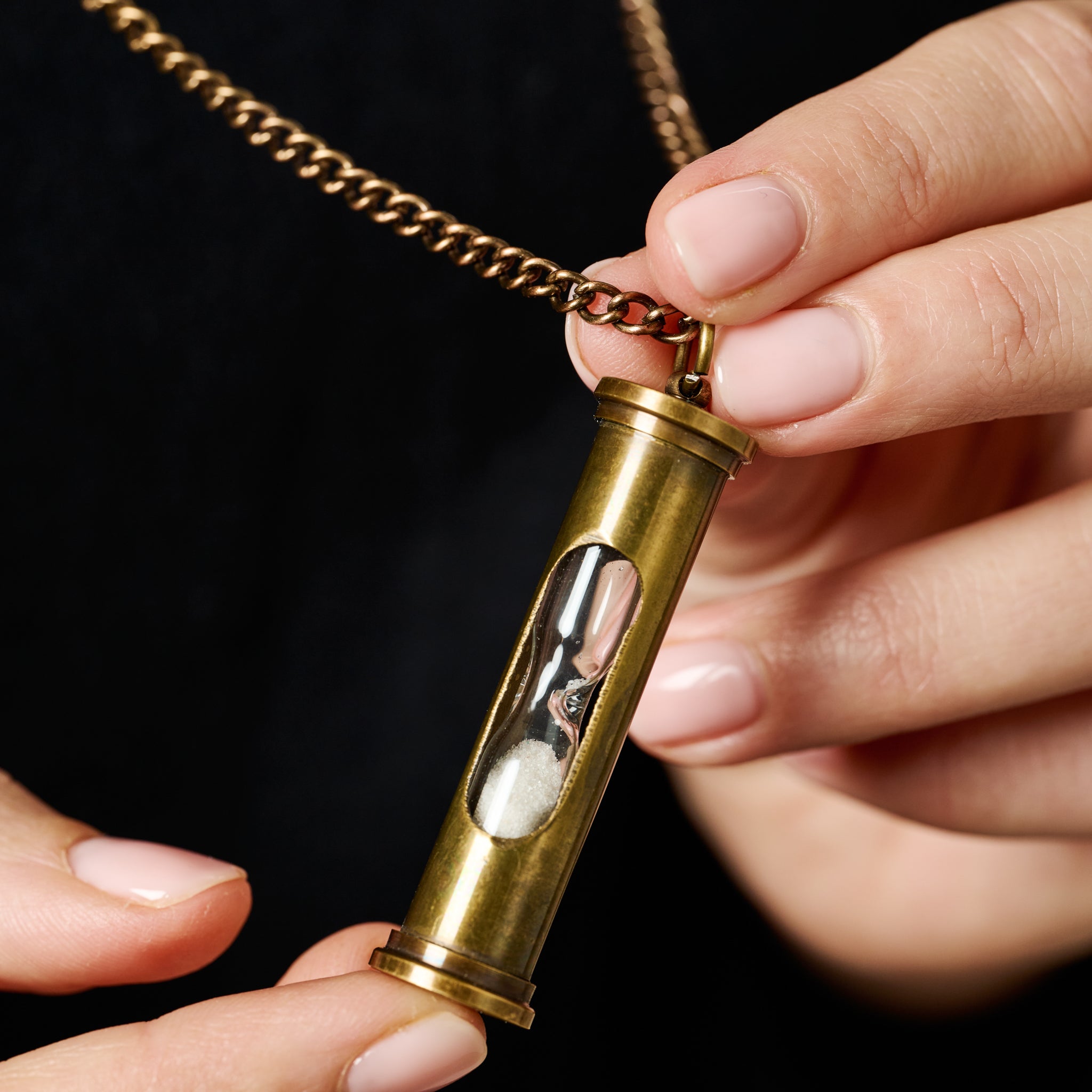 Model wearing the unique hourglass necklace, styled with a bohemian outfit, showcasing its versatility.