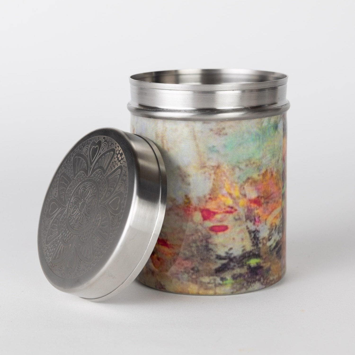 Close-up of the lid detail on a metal canister, highlighting the intricate craftsmanship.