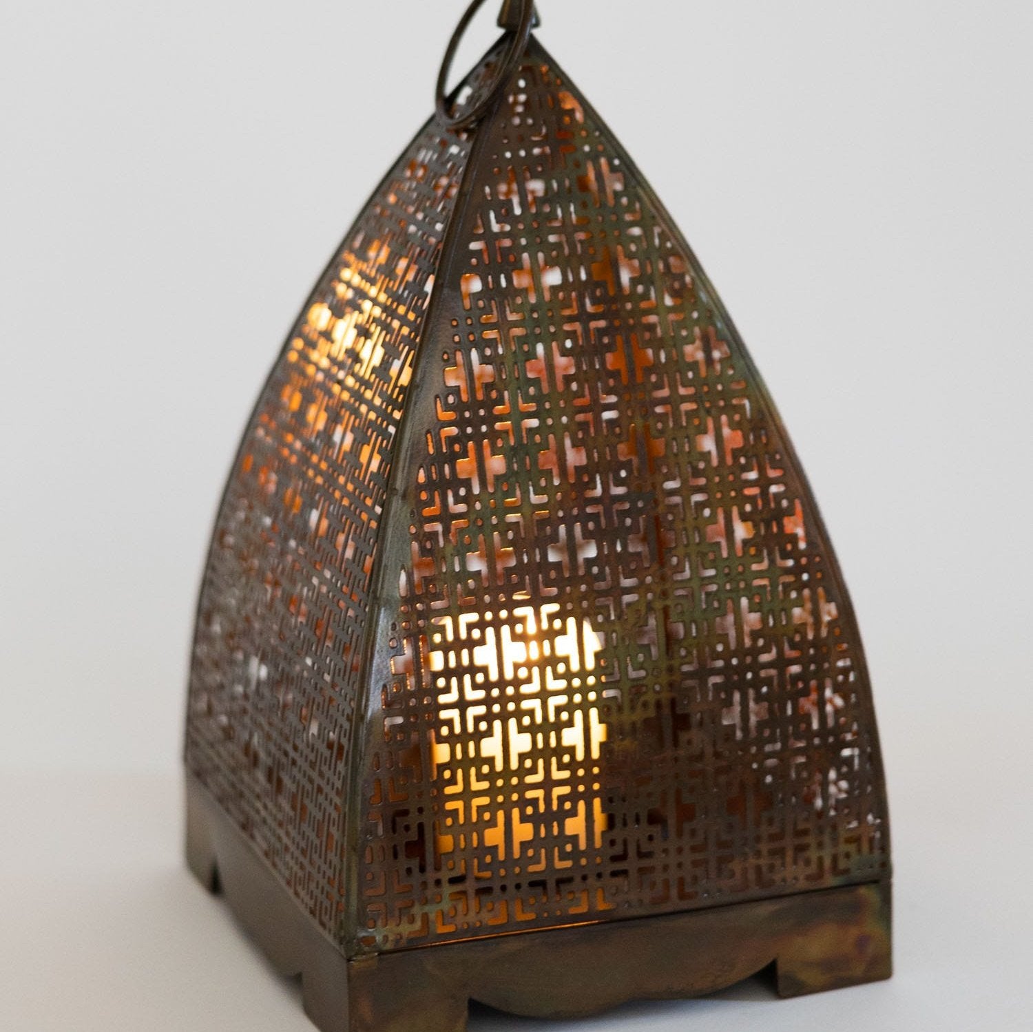 Close-up of handcrafted antique copper lantern showing detailed craftsmanship
