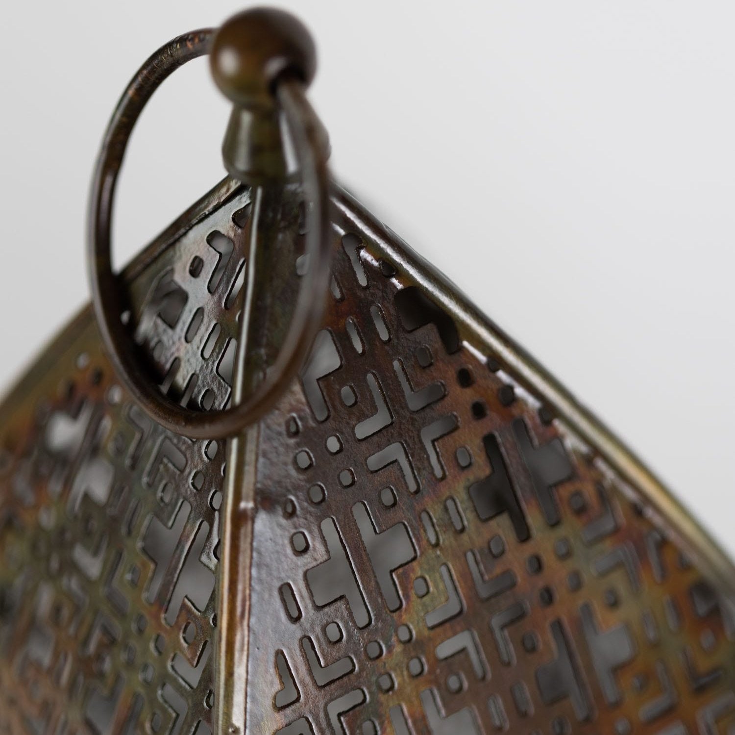 Copper lantern hanging on a patio during sunset for outdoor party ambiance