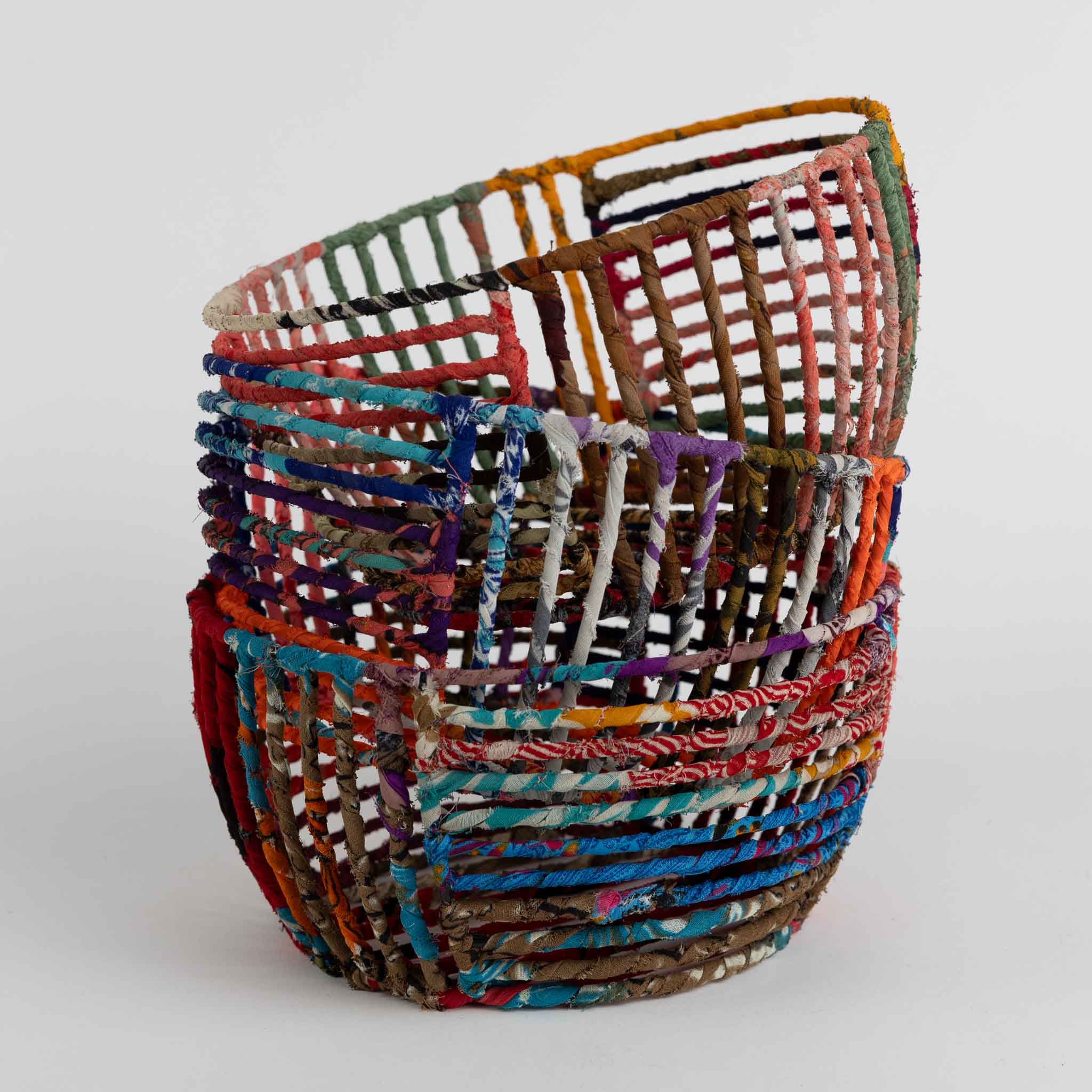 Eco-friendly wire basket for office use, showcasing colorful sari patterns.