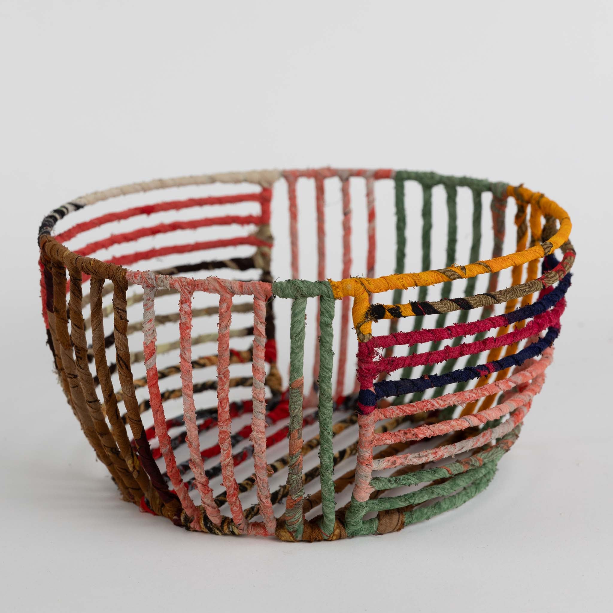 Recycled wire basket placed by the entryway, perfect for storing keys and mail.