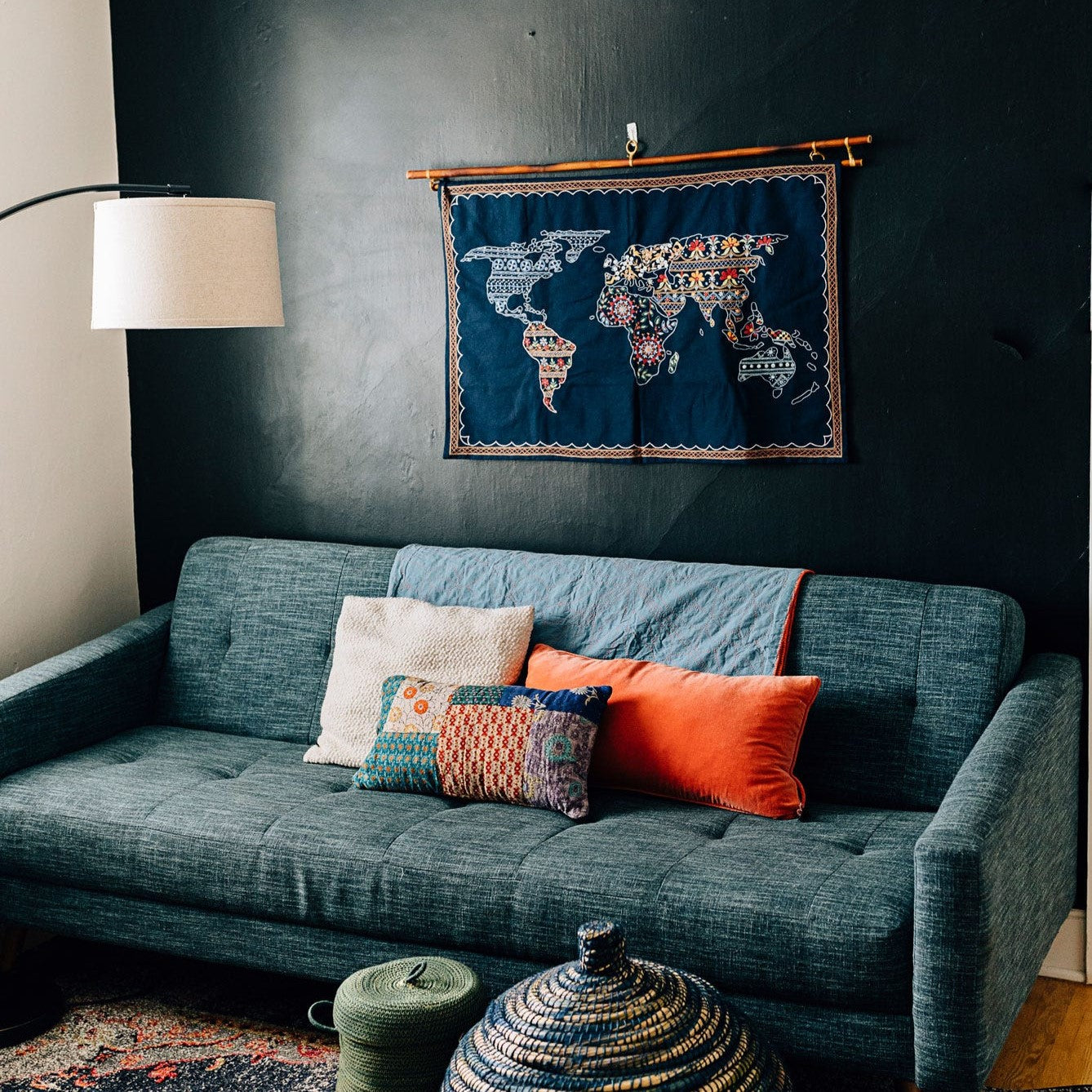 The Wanderlust Boho Wall Hanging displayed in a cozy living room, enhancing the decor with its unique cultural design.