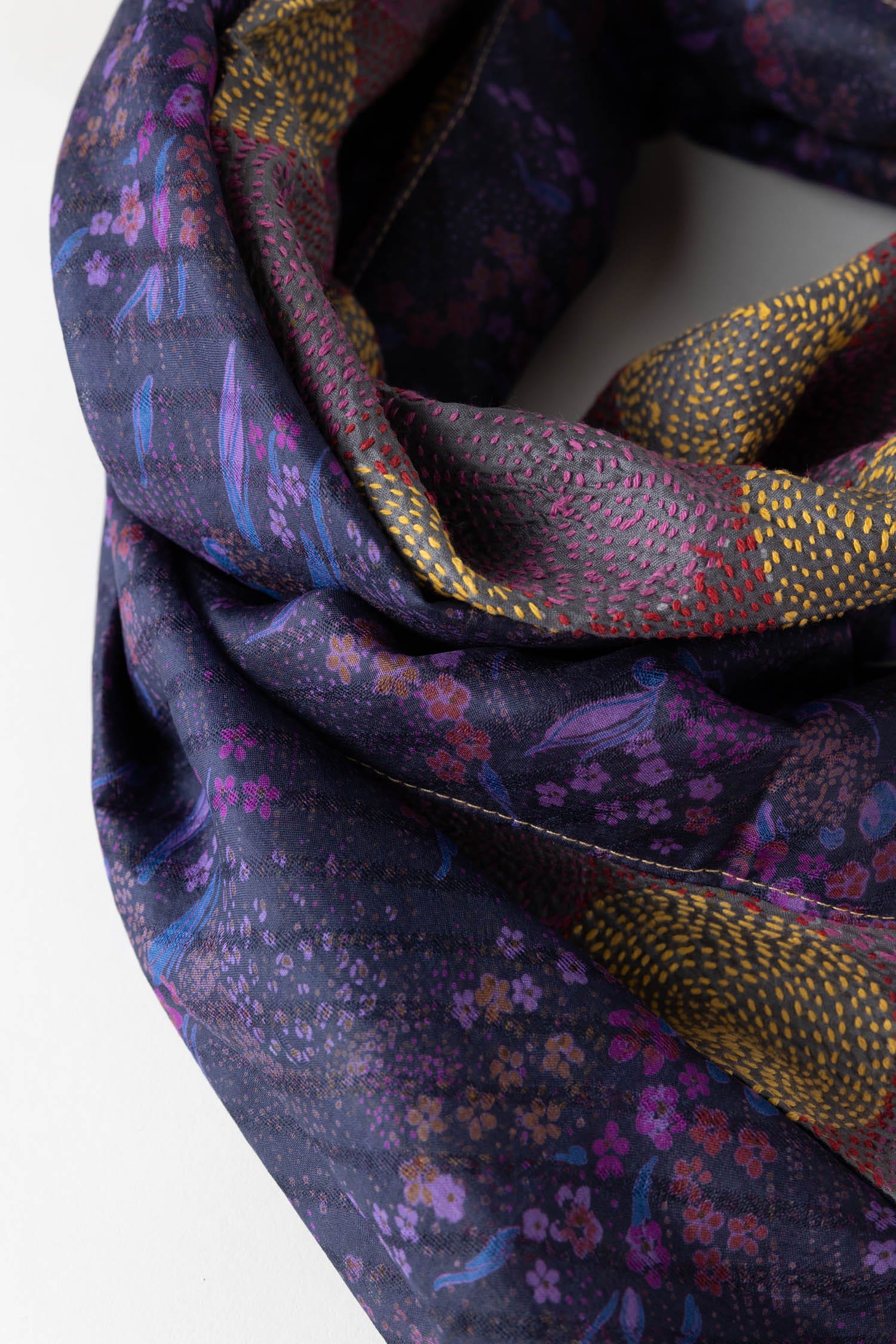 Flat lay of the silk scarf, featuring its vibrant colors and luxurious fabric against a soft background.