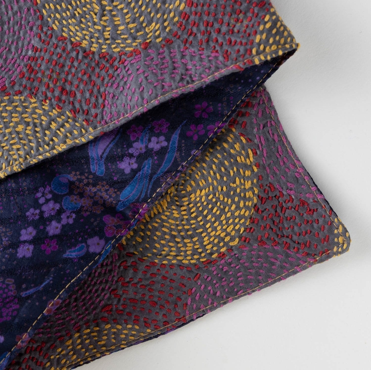 Close-up of the artisan luxury handstitched silk scarf, highlighting its intricate patterns and textures.