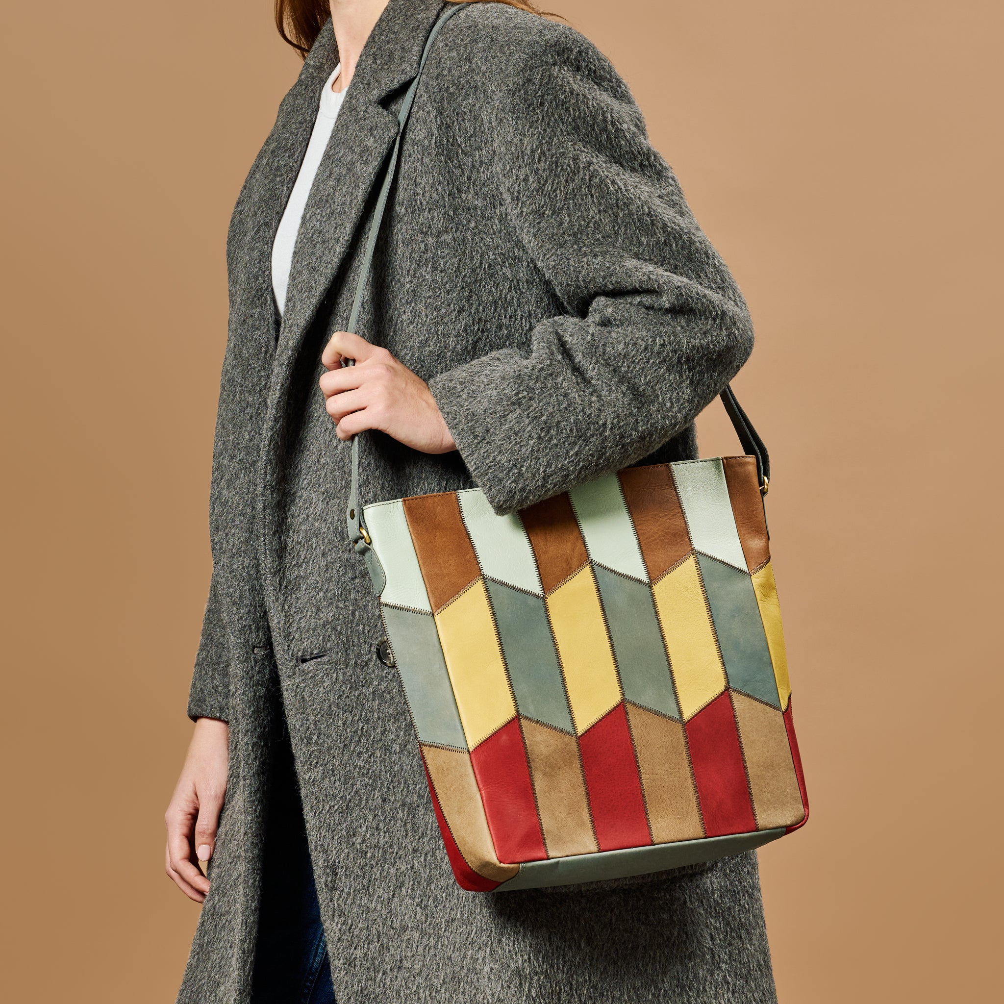 Artisan eco-leather patchwork shoulder bag showing vibrant colors and stitching