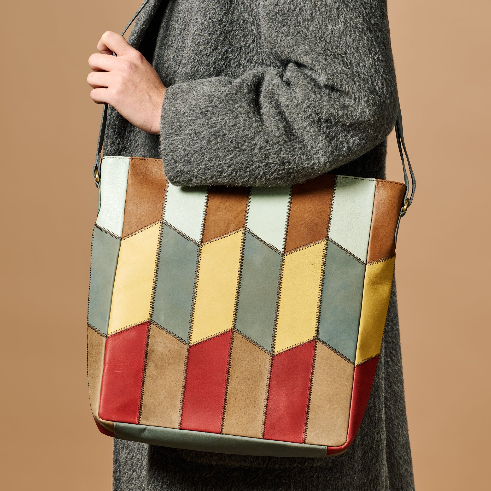 Close-up of the eco-leather shoulder bag strap with antiqued gold buckles
