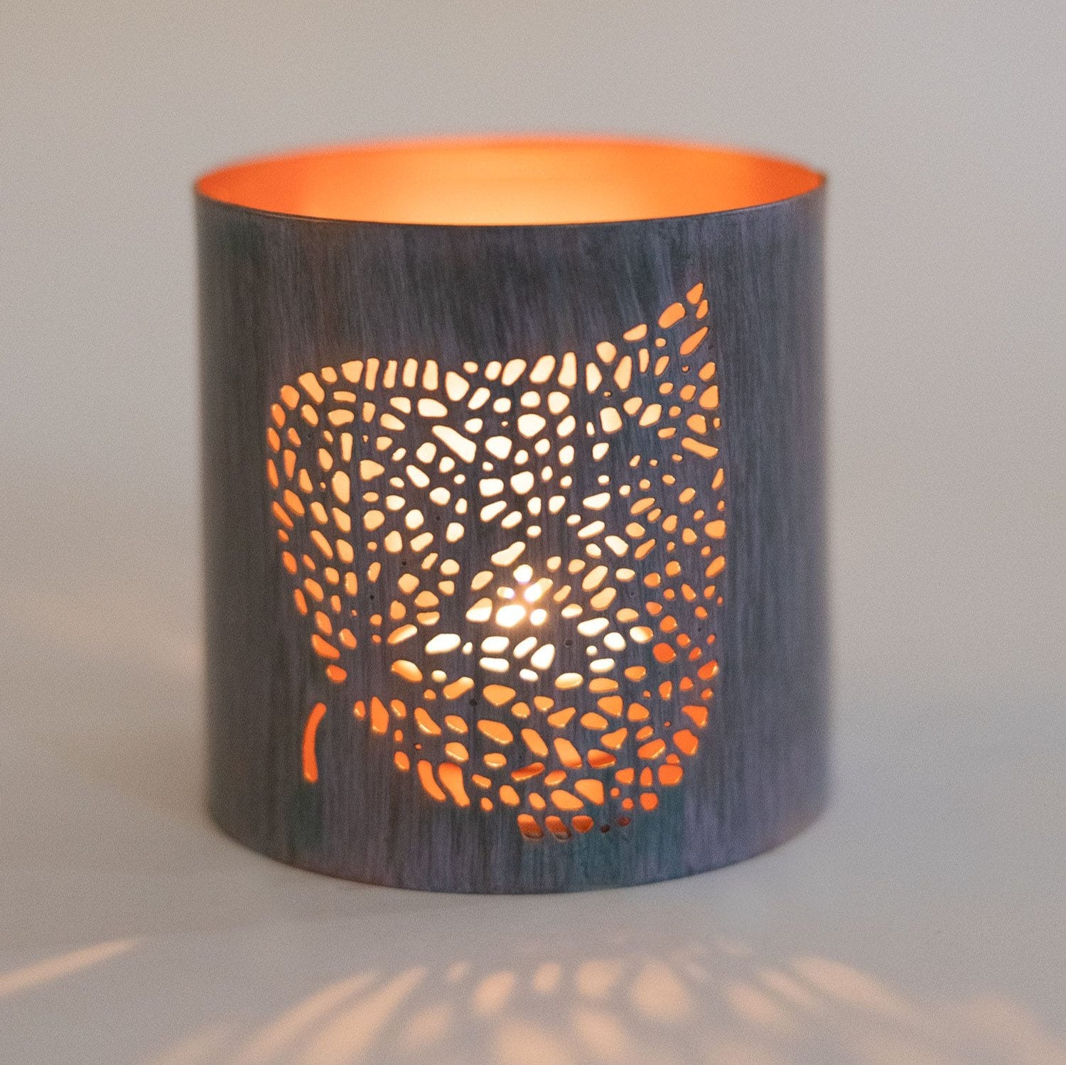 Close-up of the intricate bodhi leaf design on the iron candleholder, perfect for home decor.