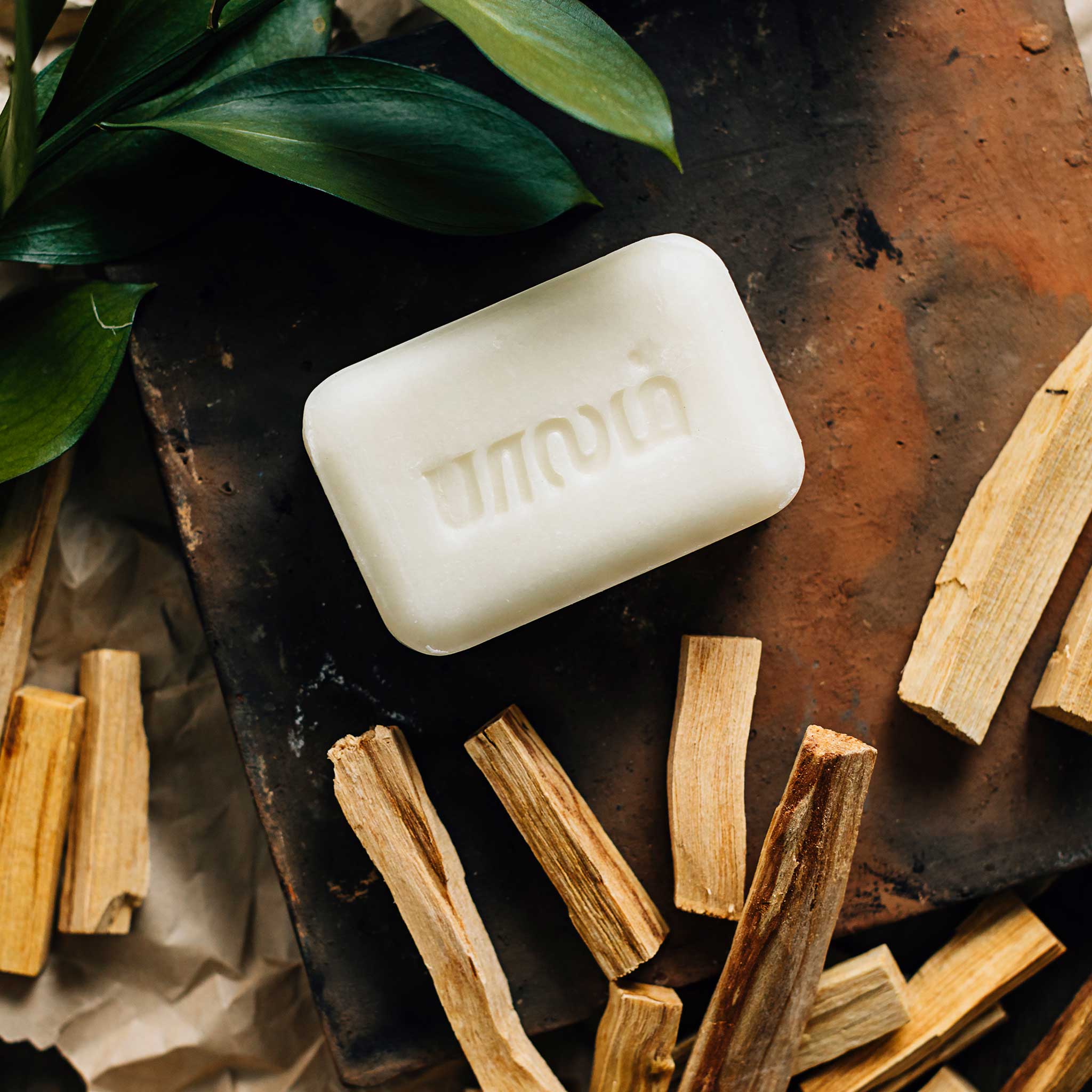 Woman applying natural sandalwood soap for skincare routine