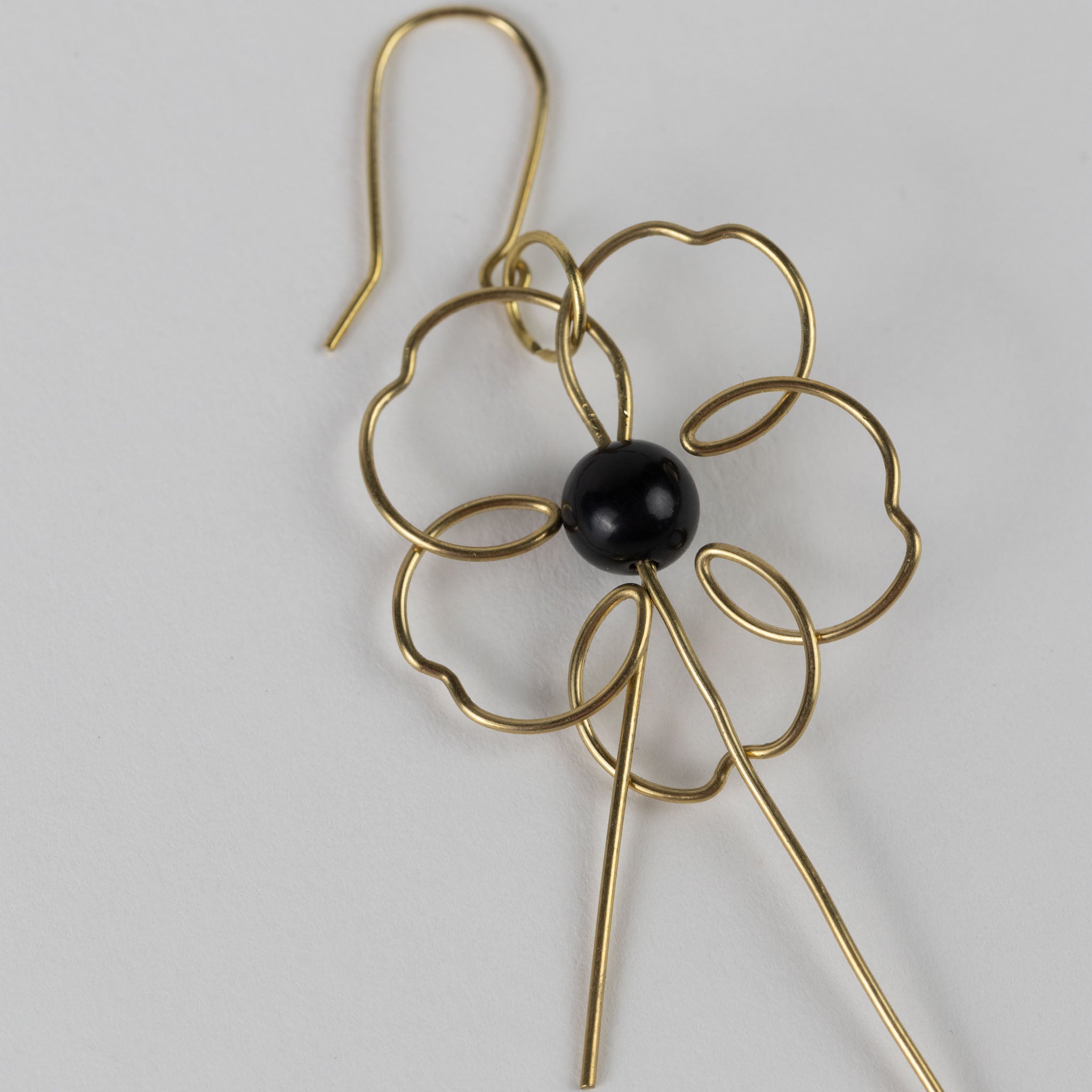Front view of handmade floral earrings with gold wire and ivory bead