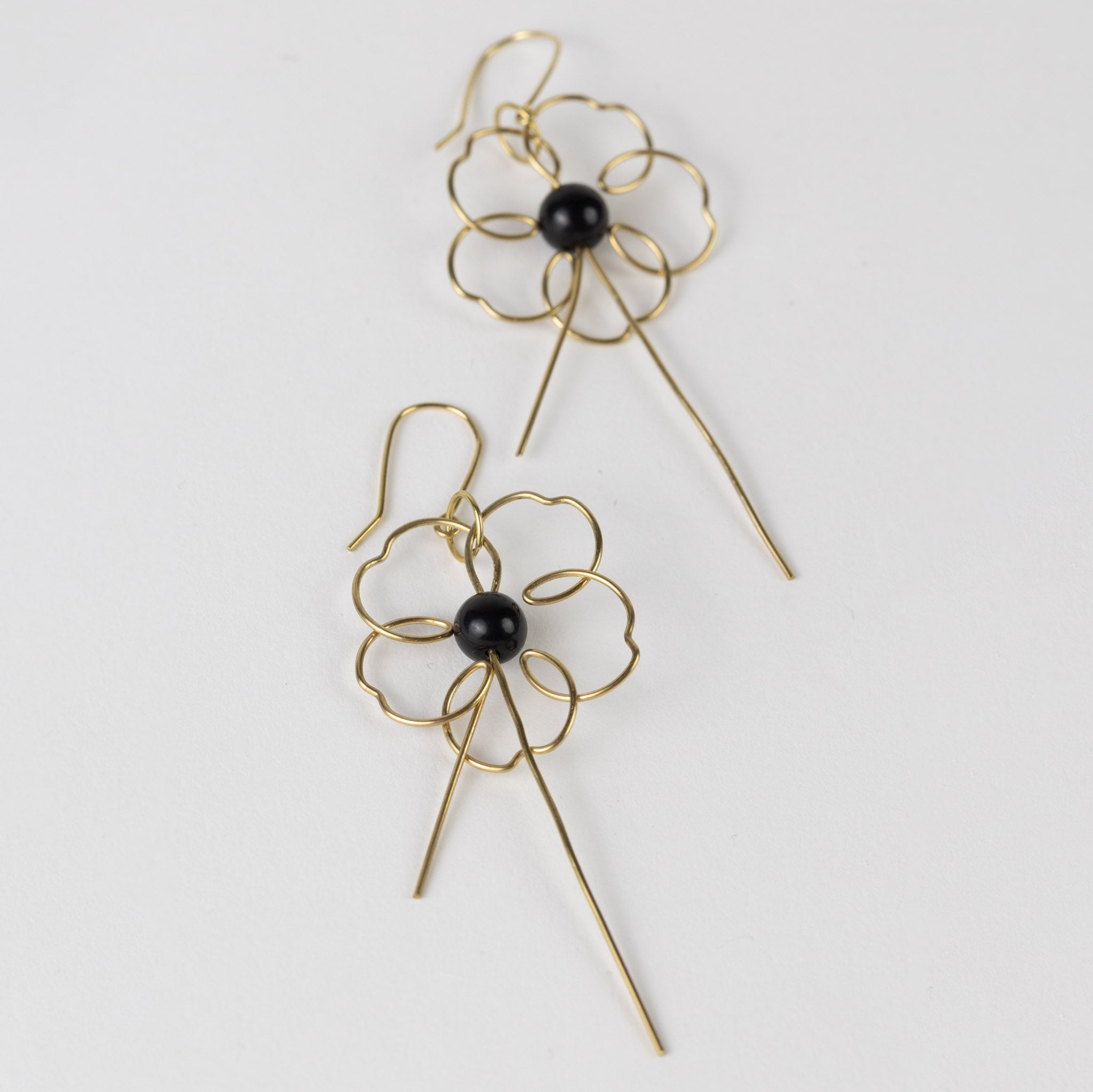 Front view of handmade floral earrings with gold wire and ivory bead