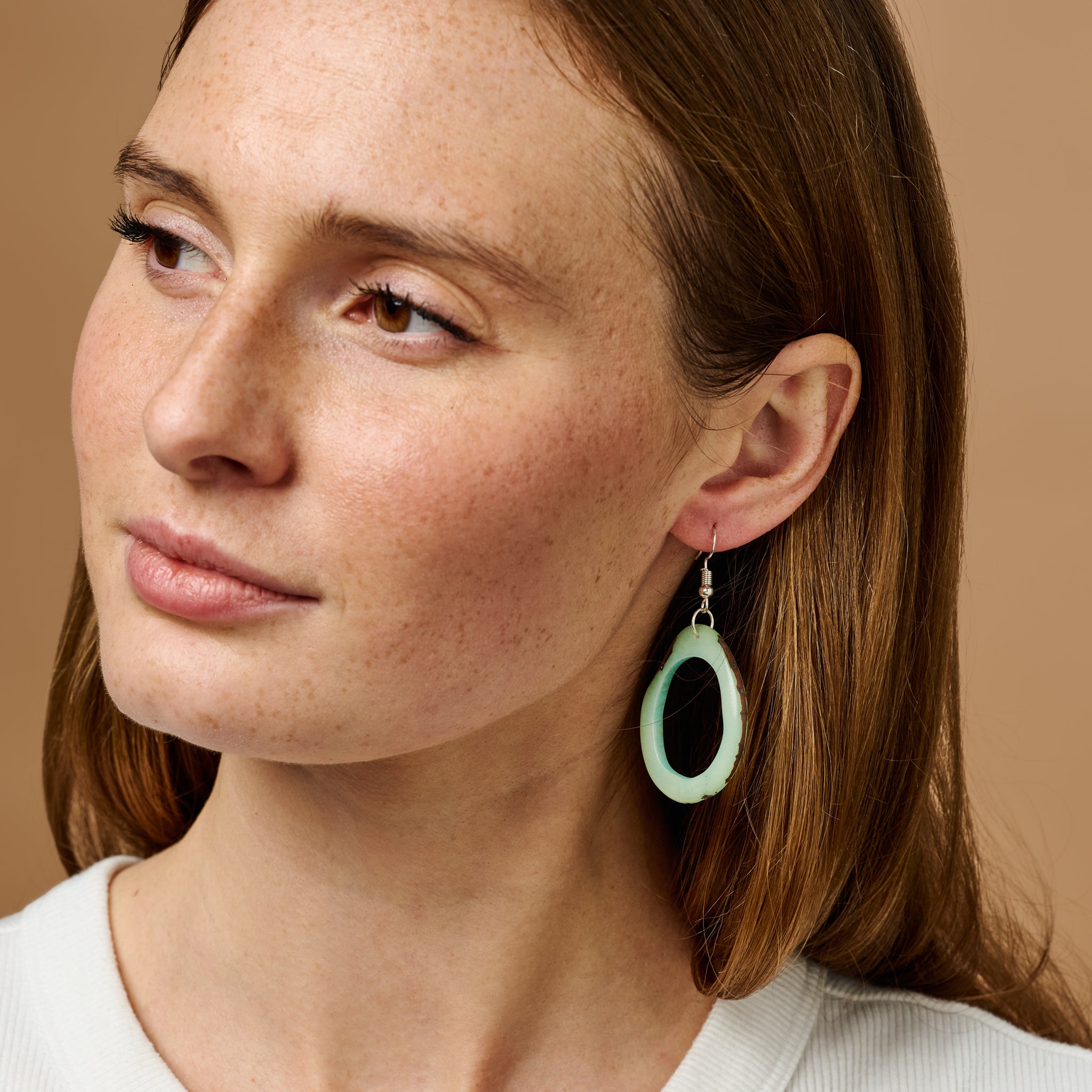 Close-up of vibrant mint Seafoam Tagua Earrings showing their eco-friendly craftsmanship