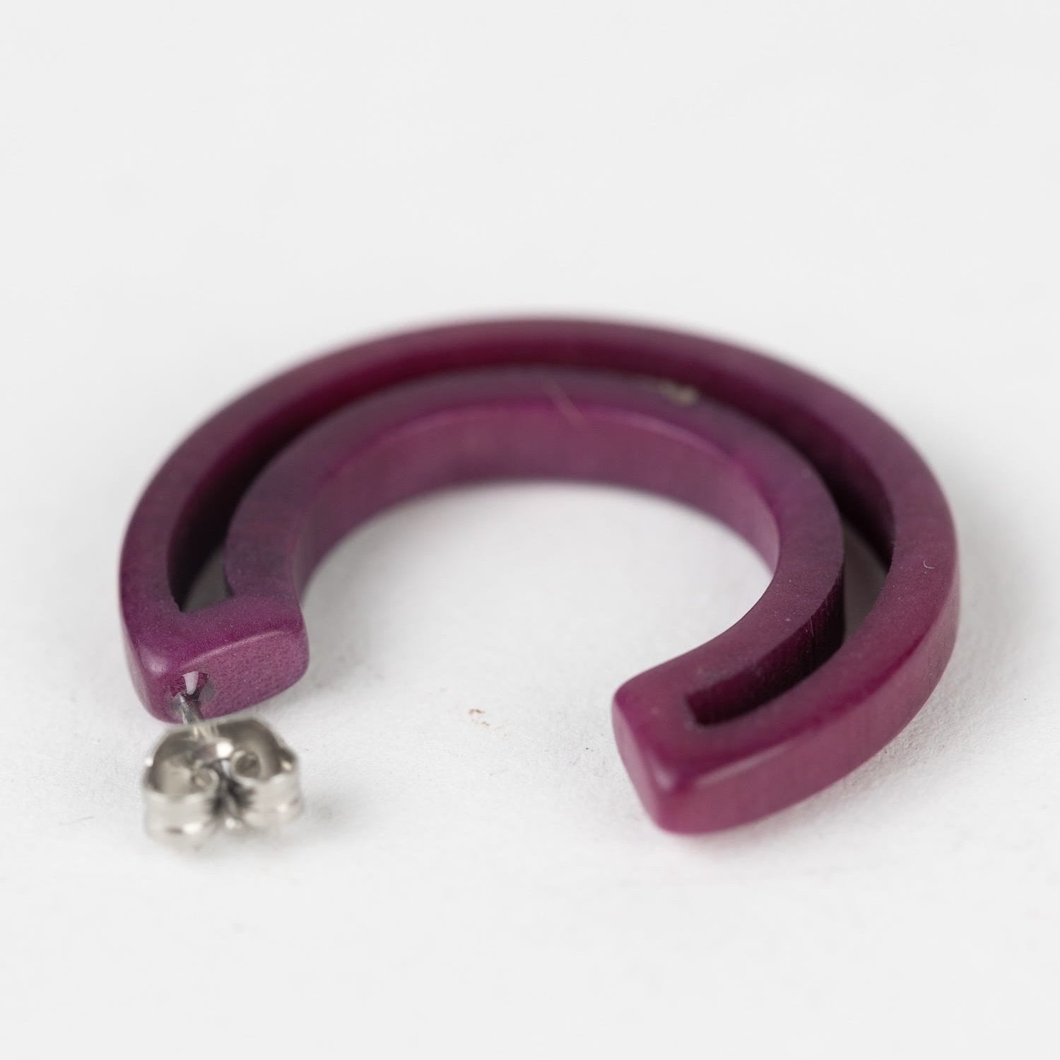 Close-up view of eco-friendly hoop earrings showcasing intricate craftsmanship and minimalist design.