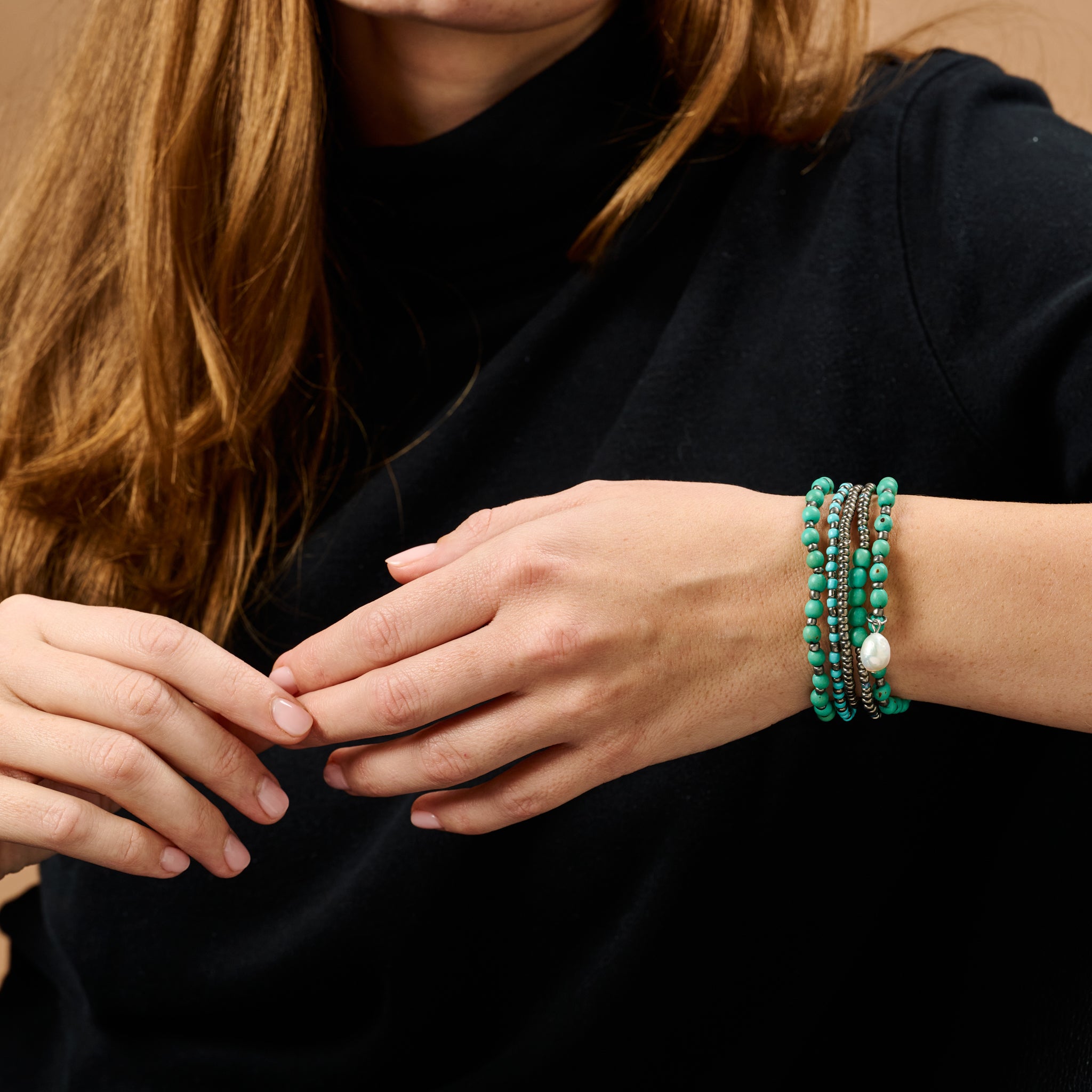 Close-up of Aqua Elegance bracelet highlighting the freshwater pearl and vibrant seed beads.