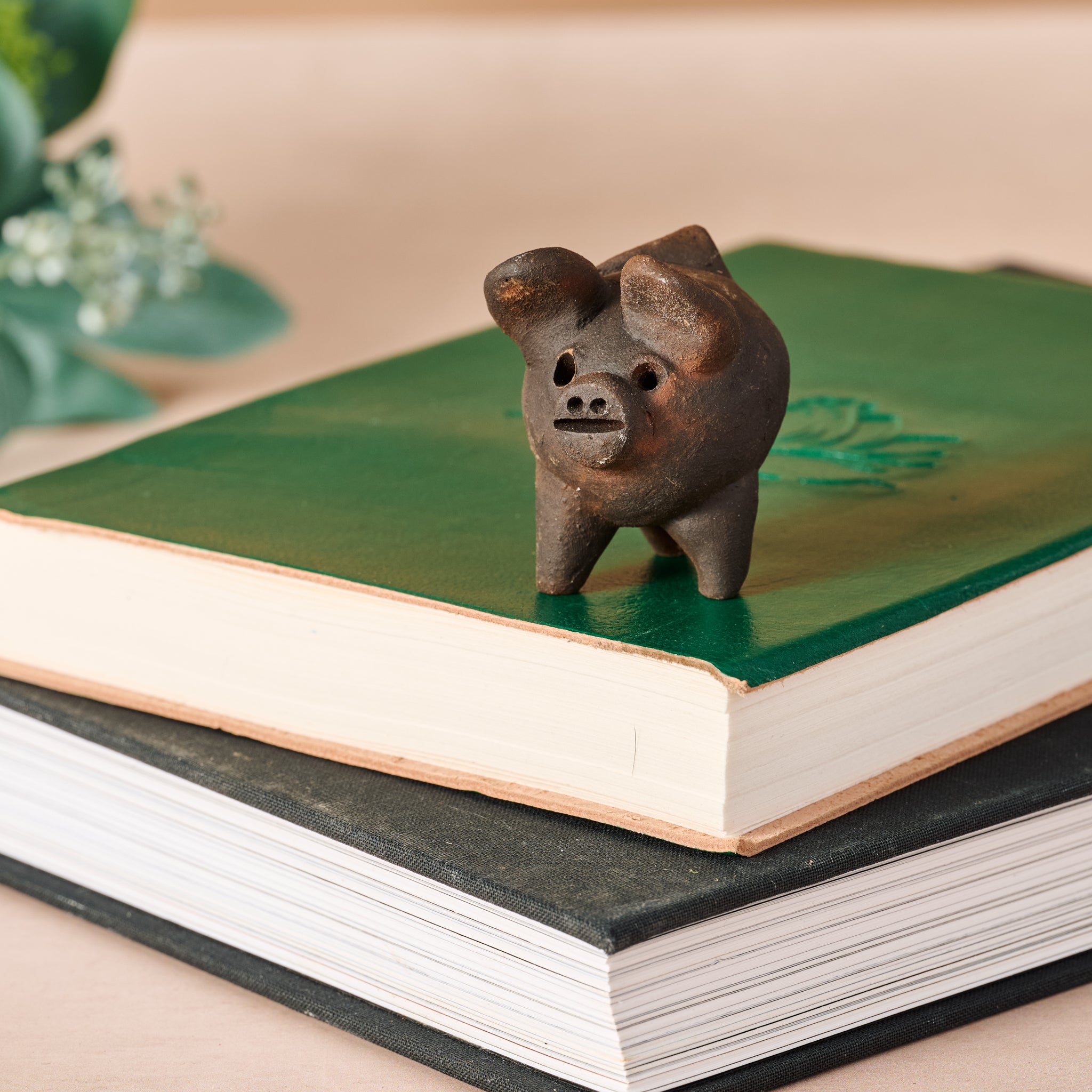 Charming terracotta good luck pig figurine from Pomaire, Chile, showcasing its intricate details.