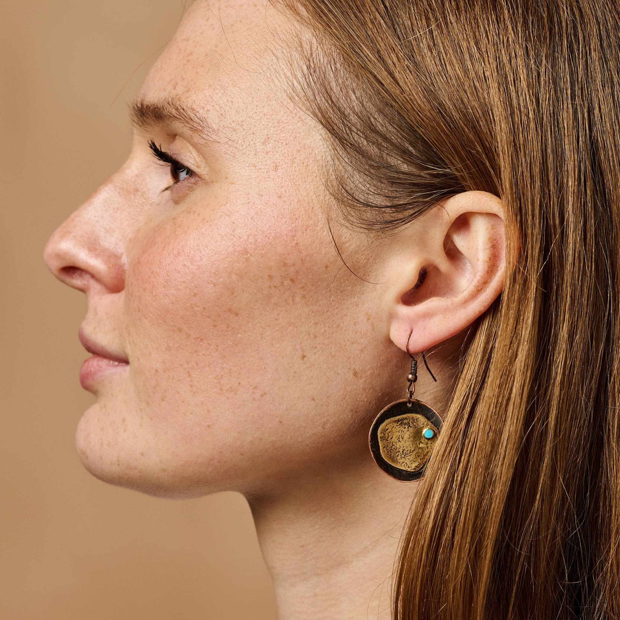 Side view of Coastal Chic hammered copper earrings, showcasing their unique design.