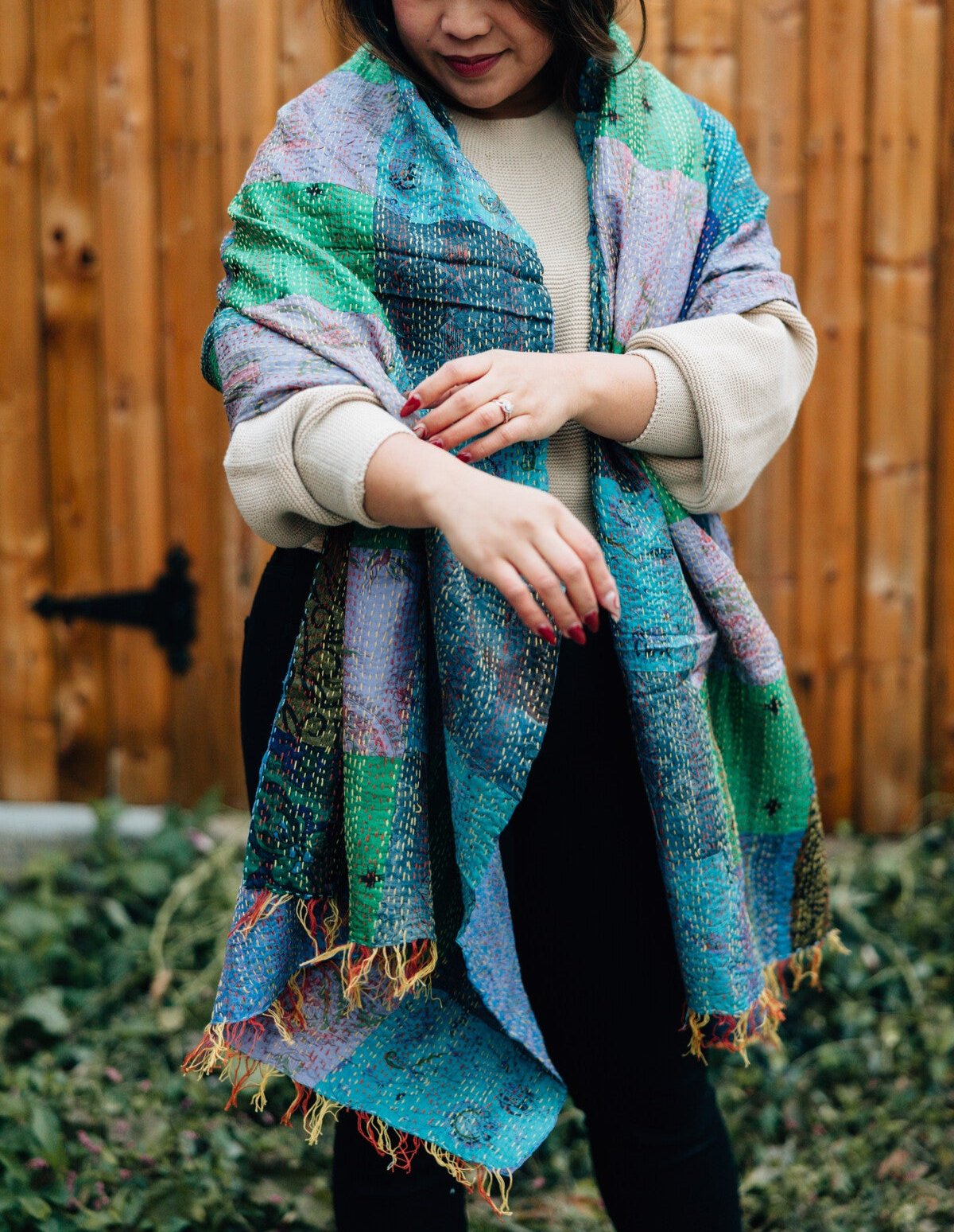Close-up of patchwork silk kantha shawl with detailed stitching