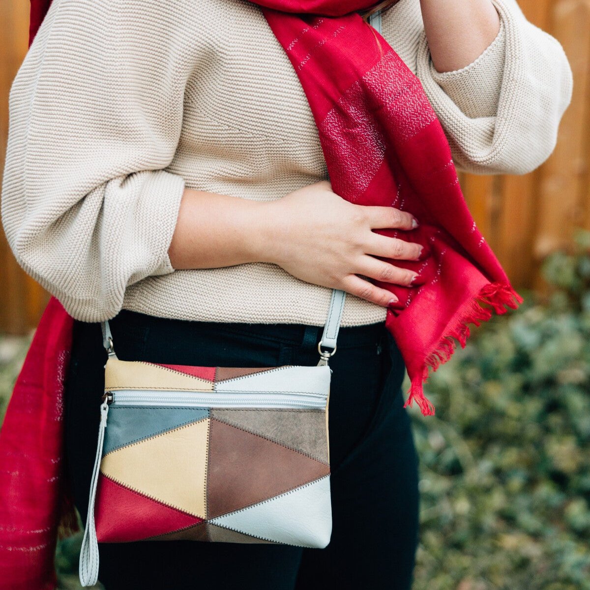 Eco-leather convertible purse showcasing patchwork design and green strap.