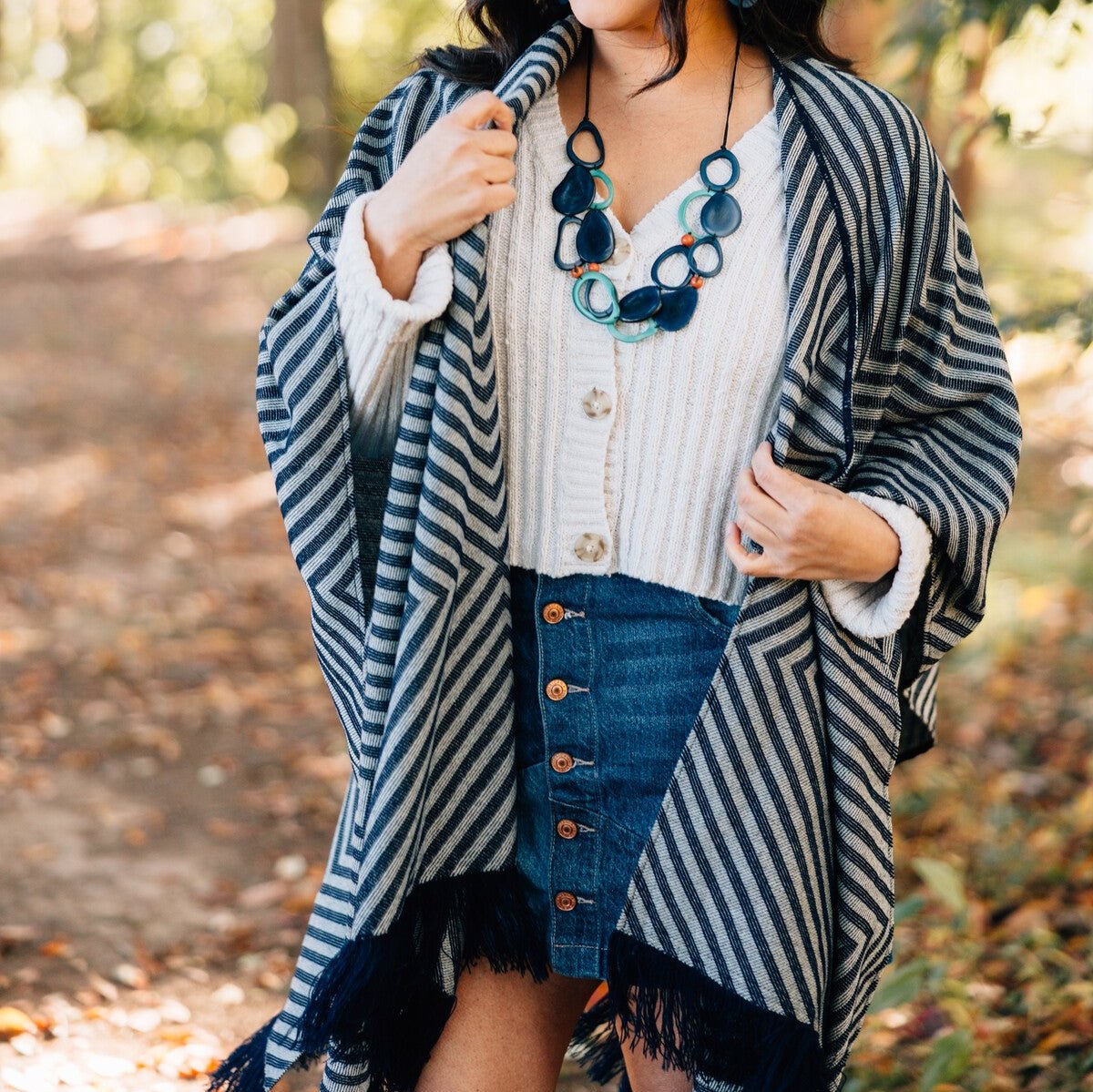 Open front view of the chic black and white poncho, showcasing its elegant design.