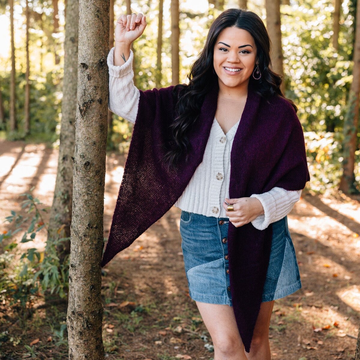 Front view of burgundy alpaca triangle shawl draped over shoulders, showcasing its rich color and texture