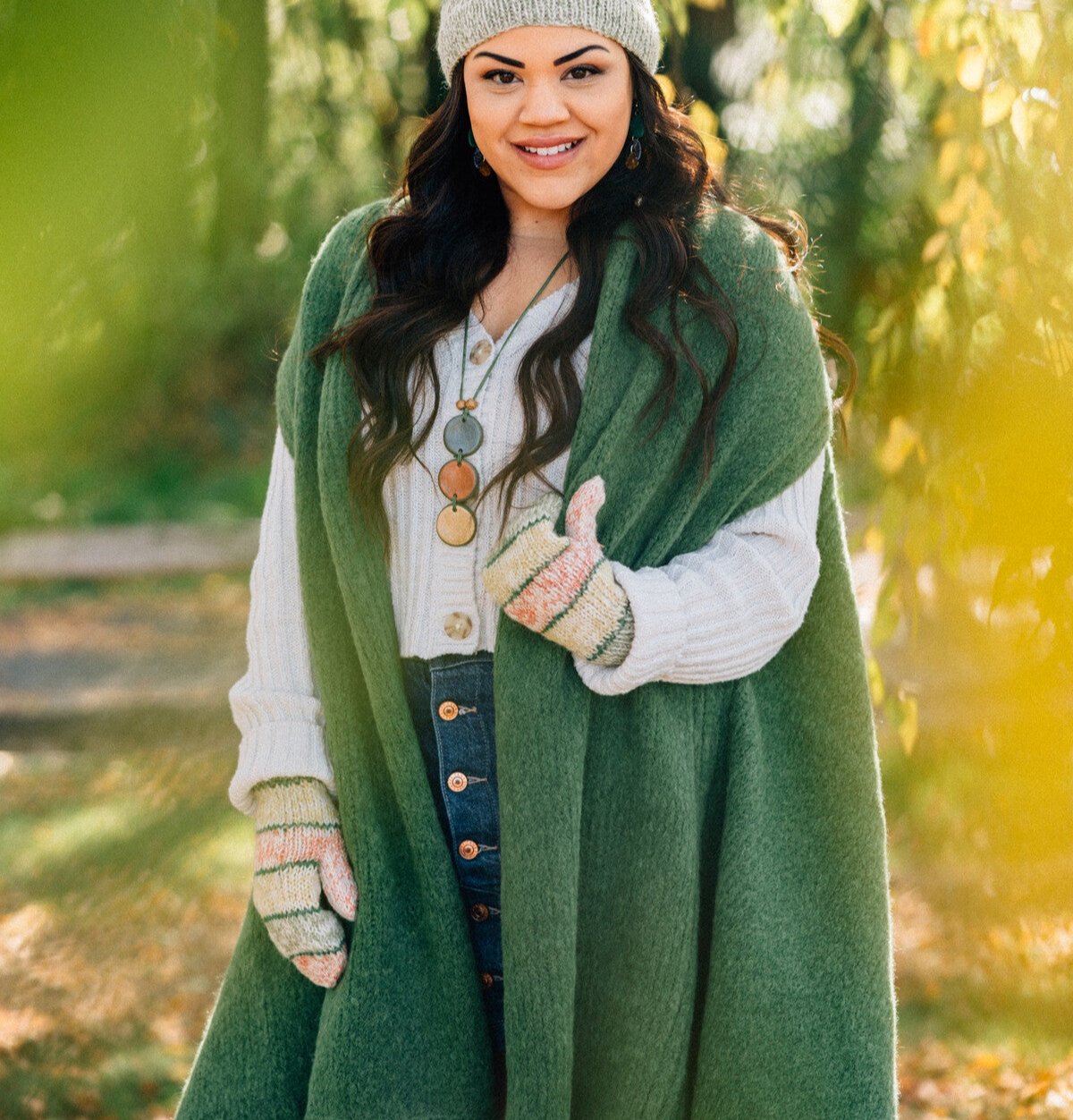 Elegant earthy green luxury alpaca shawl draped over a chair.
