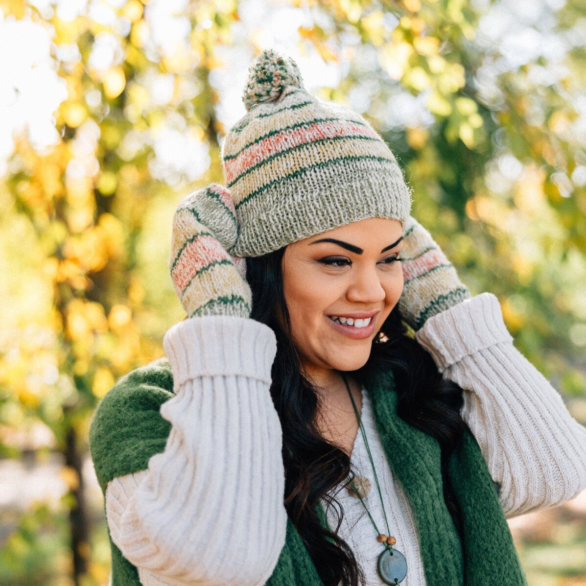 Person wearing the wool beanie with pom pom while walking in winter city