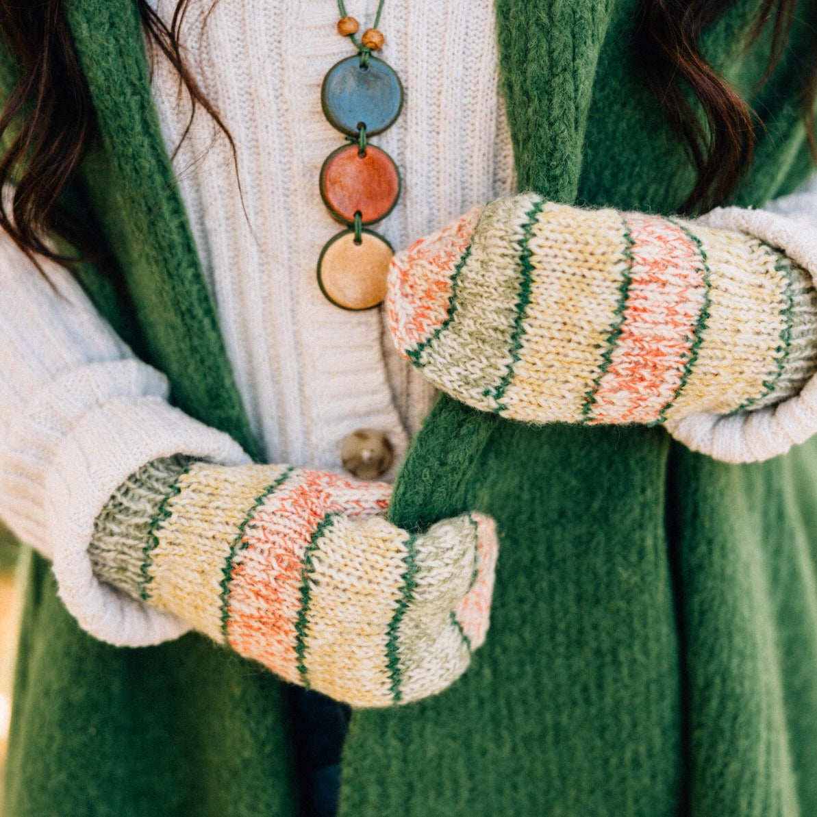 Artisan Candy Shoppe Mittens displayed on a rustic wooden table, perfect for cold weather.