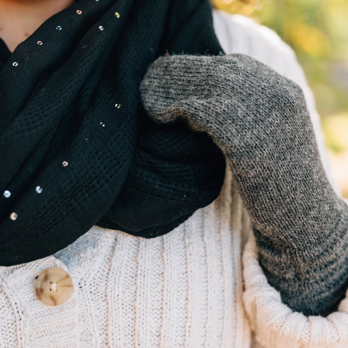 Hand-knit alpaca wool mittens in grey, perfect for cold weather outings.