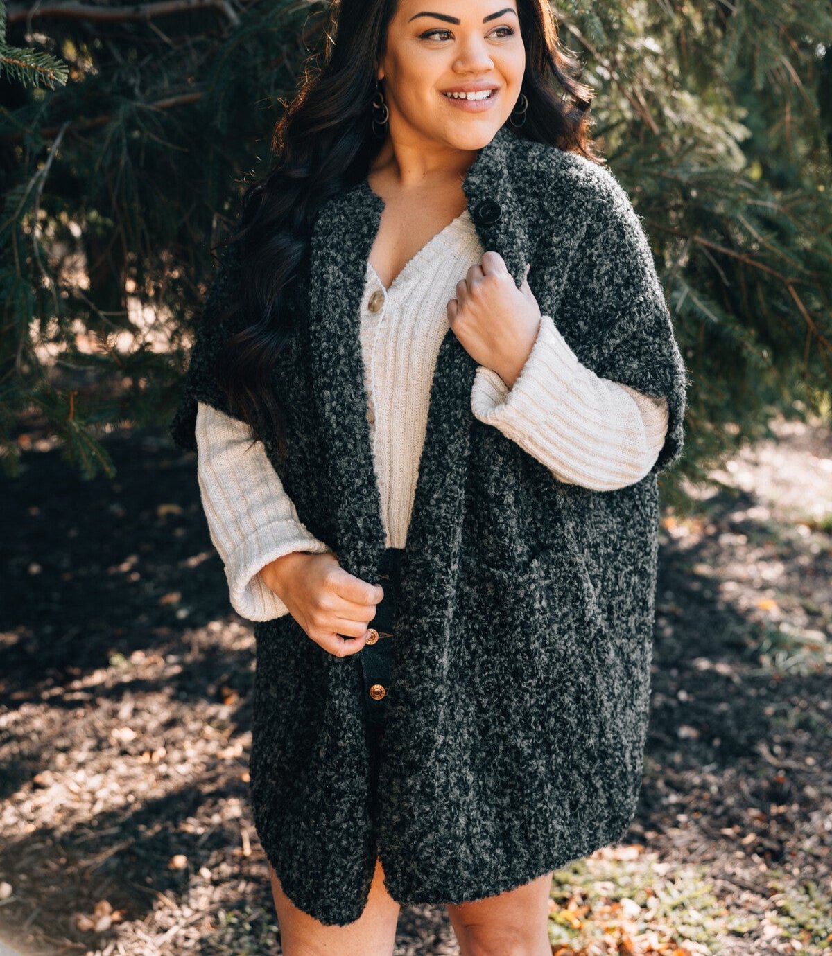 Model wearing the oversized cardigan, highlighting the off-the-shoulder sleeves and pockets.
