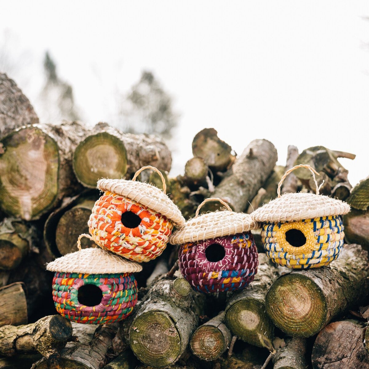 Front view of the handcrafted birdhouse with natural materials and vibrant colors
