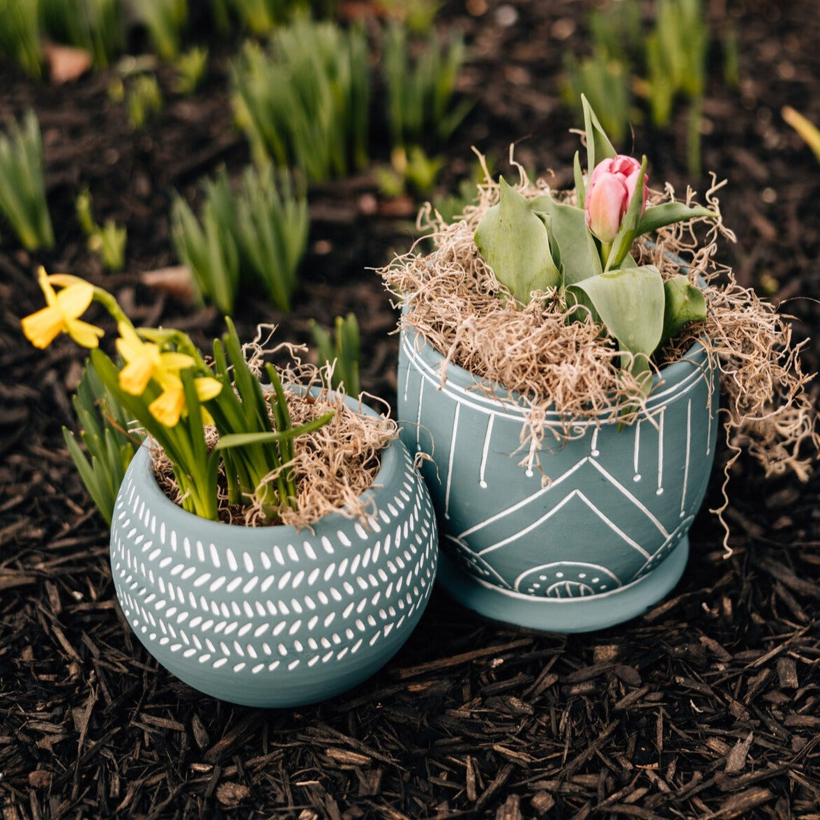 Geo teal terracotta planter showcasing its unique geometric patterns from a side angle.