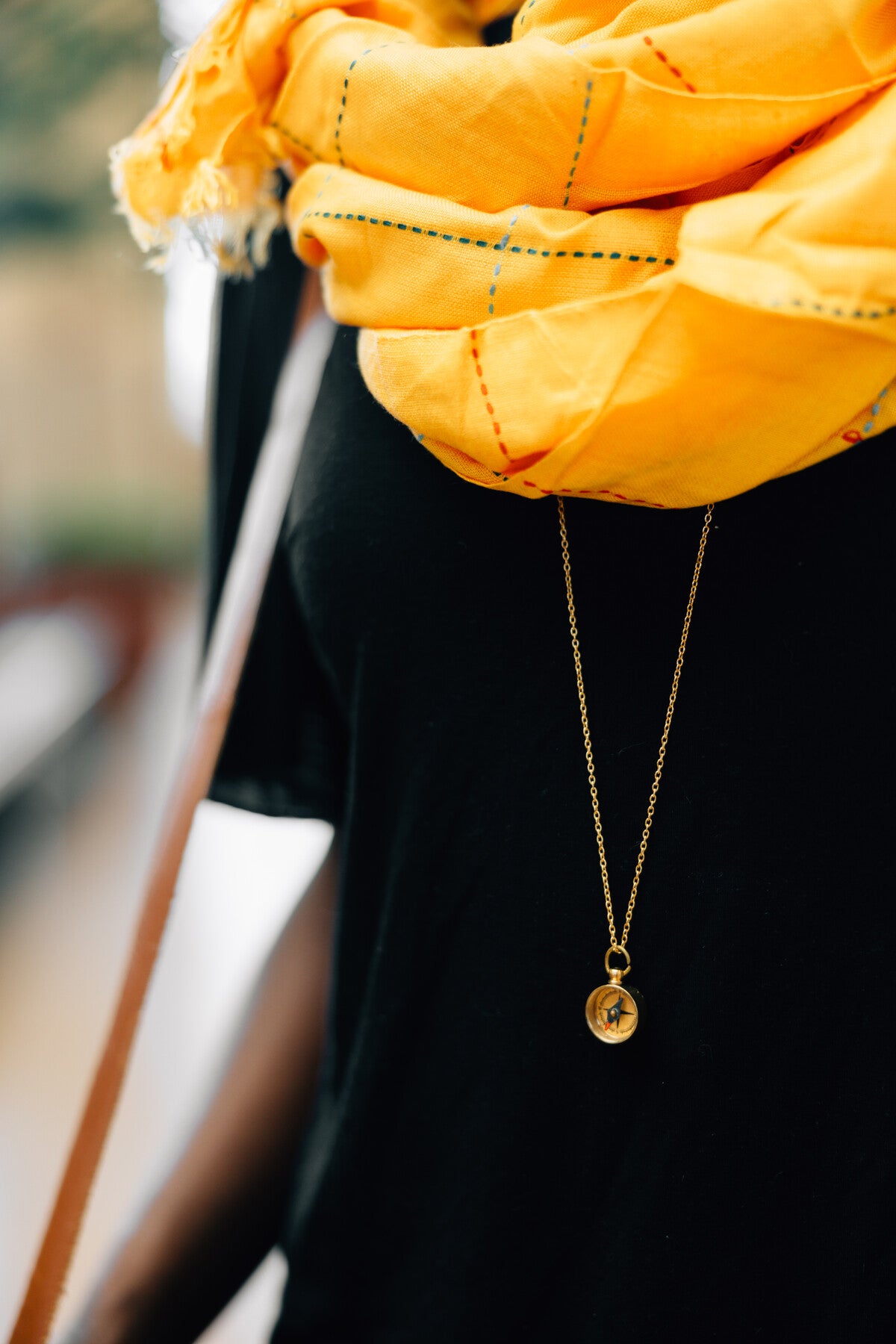 Compass necklace with long chain styled for layering with other adventure jewelry pieces