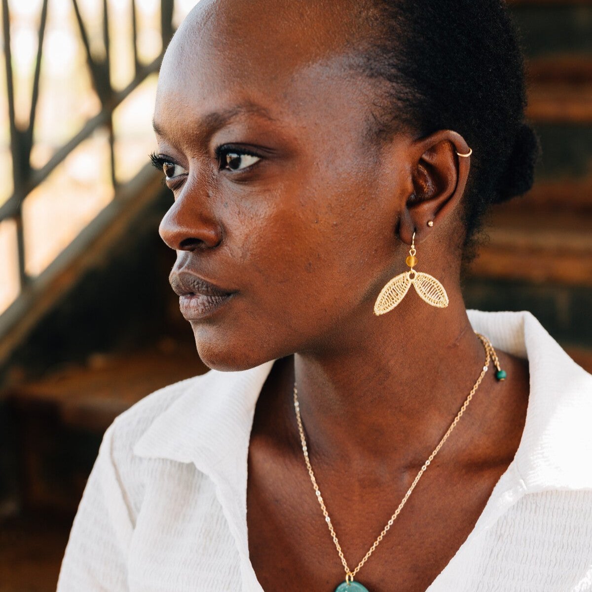 Close-up of Samaras Artisan Gold Earrings with delicate golden wings against a soft background.