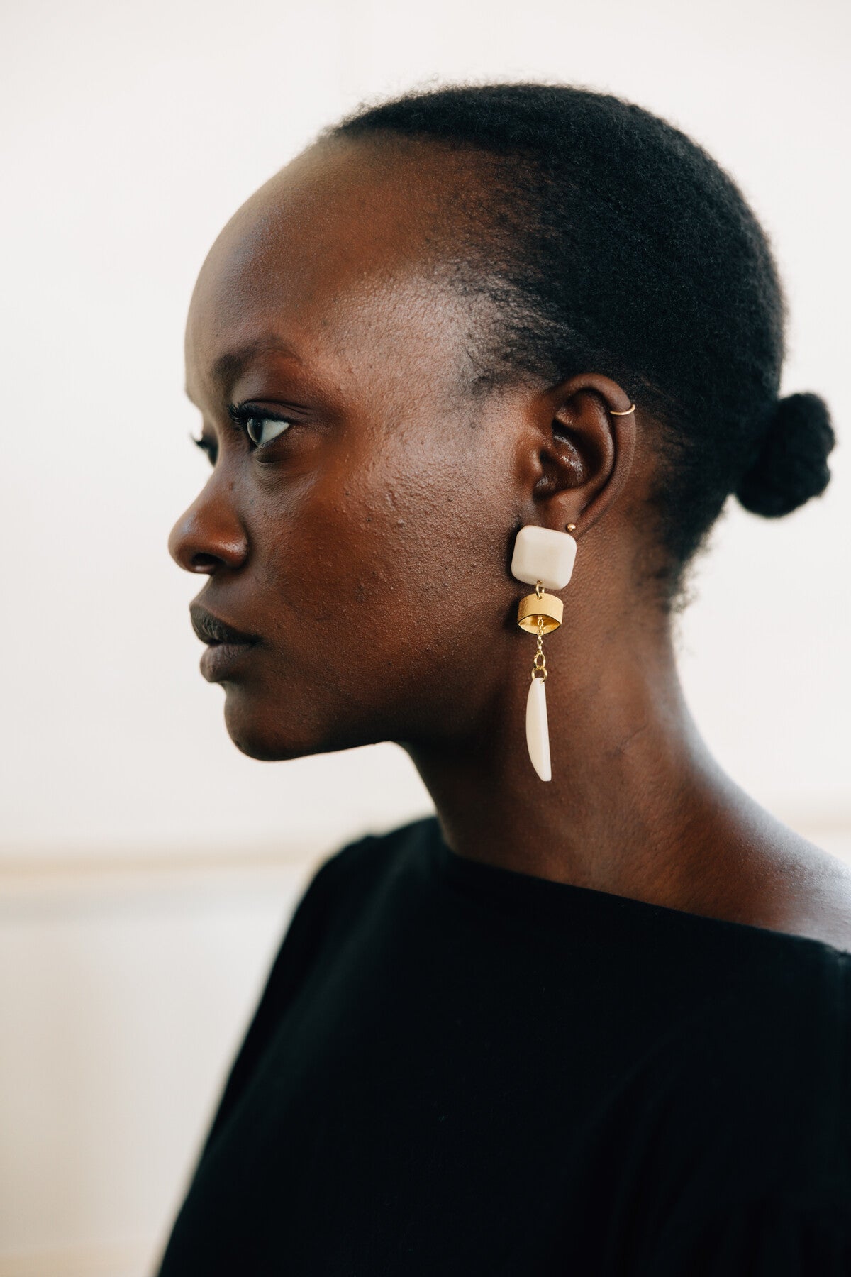 Side view of gold dangle earrings made from ethical materials, perfect for special occasions.