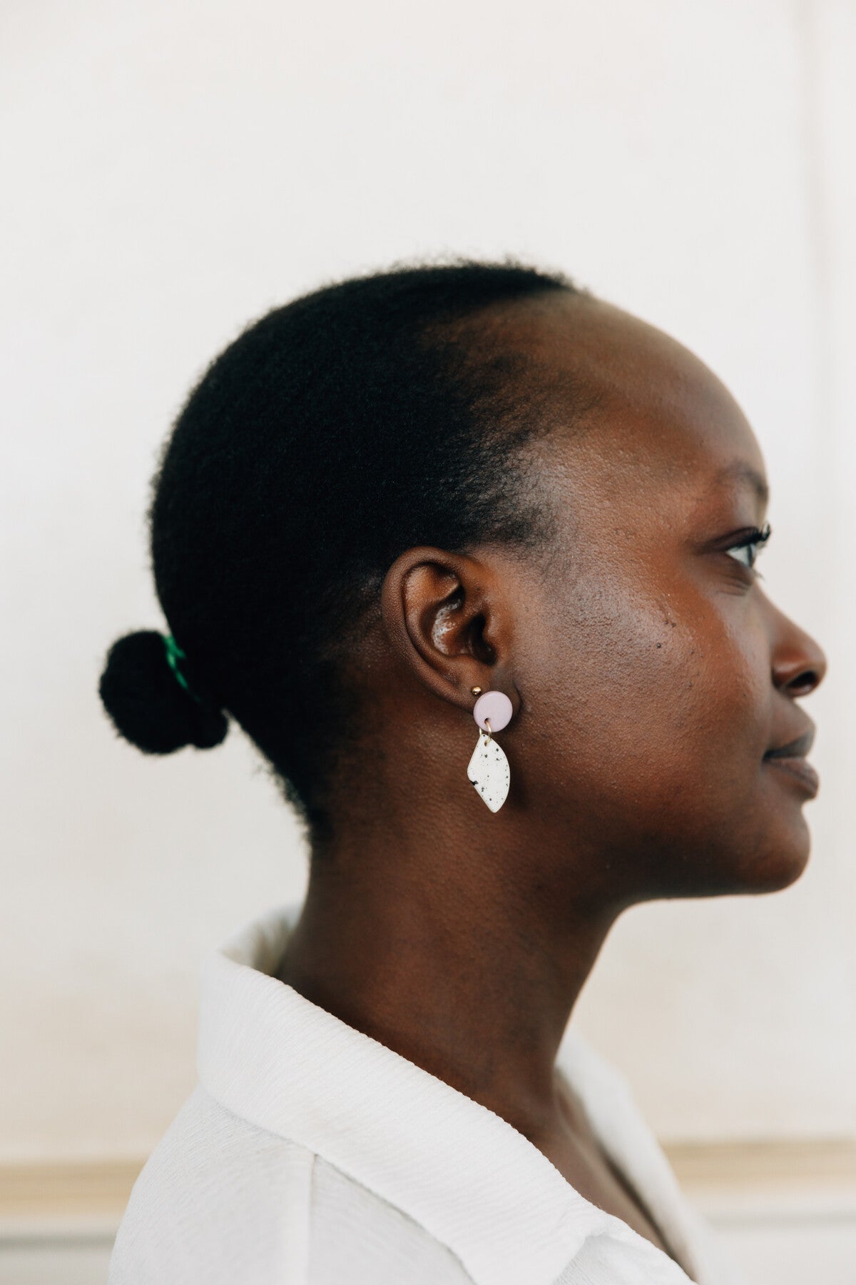 Model wearing eco-friendly dangle earrings for a boho-chic look