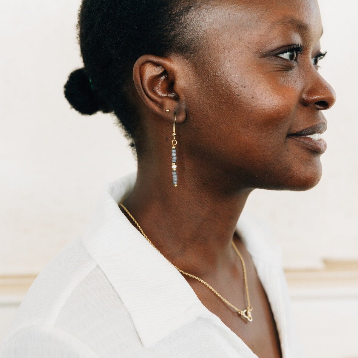 Close-up of eco-friendly pale blue dangle earrings showcasing the craftsmanship.