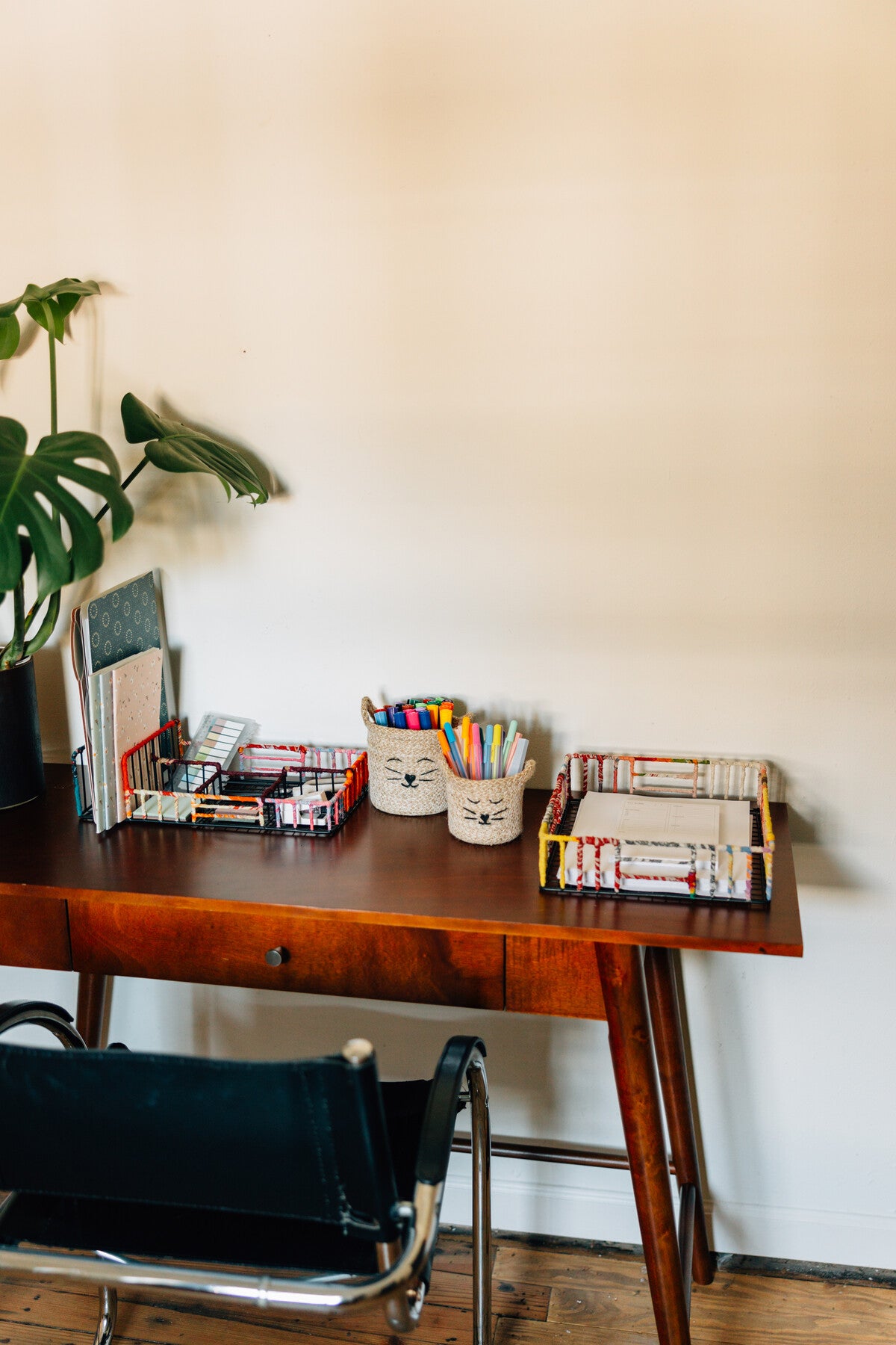 Desk setup featuring a handcrafted sari organizer for office supplies