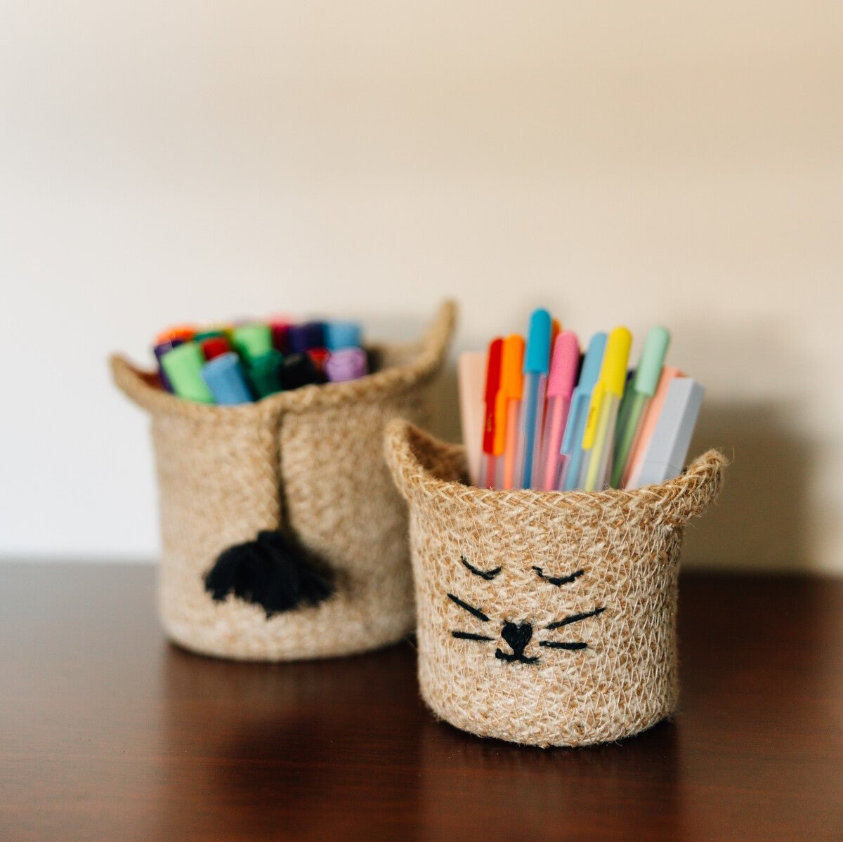 Stylish jute basket with a playful cat face, suitable as a decorative piece or plant holder.