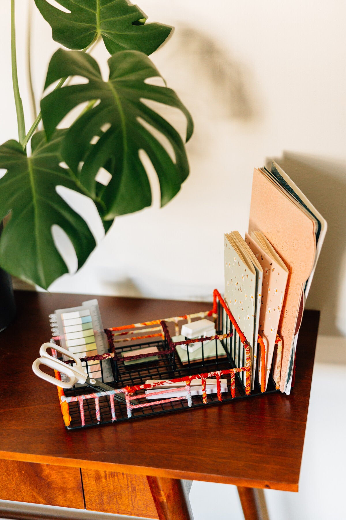 Desk setup featuring a handcrafted sari organizer for office supplies