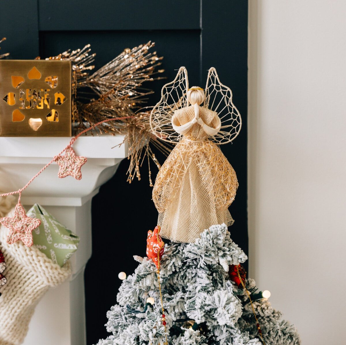 Close-up view of the handcrafted sinamay angel tree topper showcasing its intricate design and gold halo.