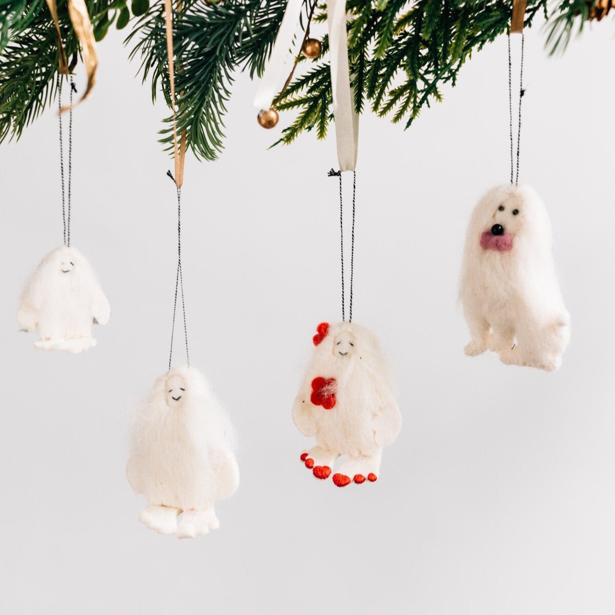 Yeti ornament displayed on a festive holiday tree, adding charm to the decor.