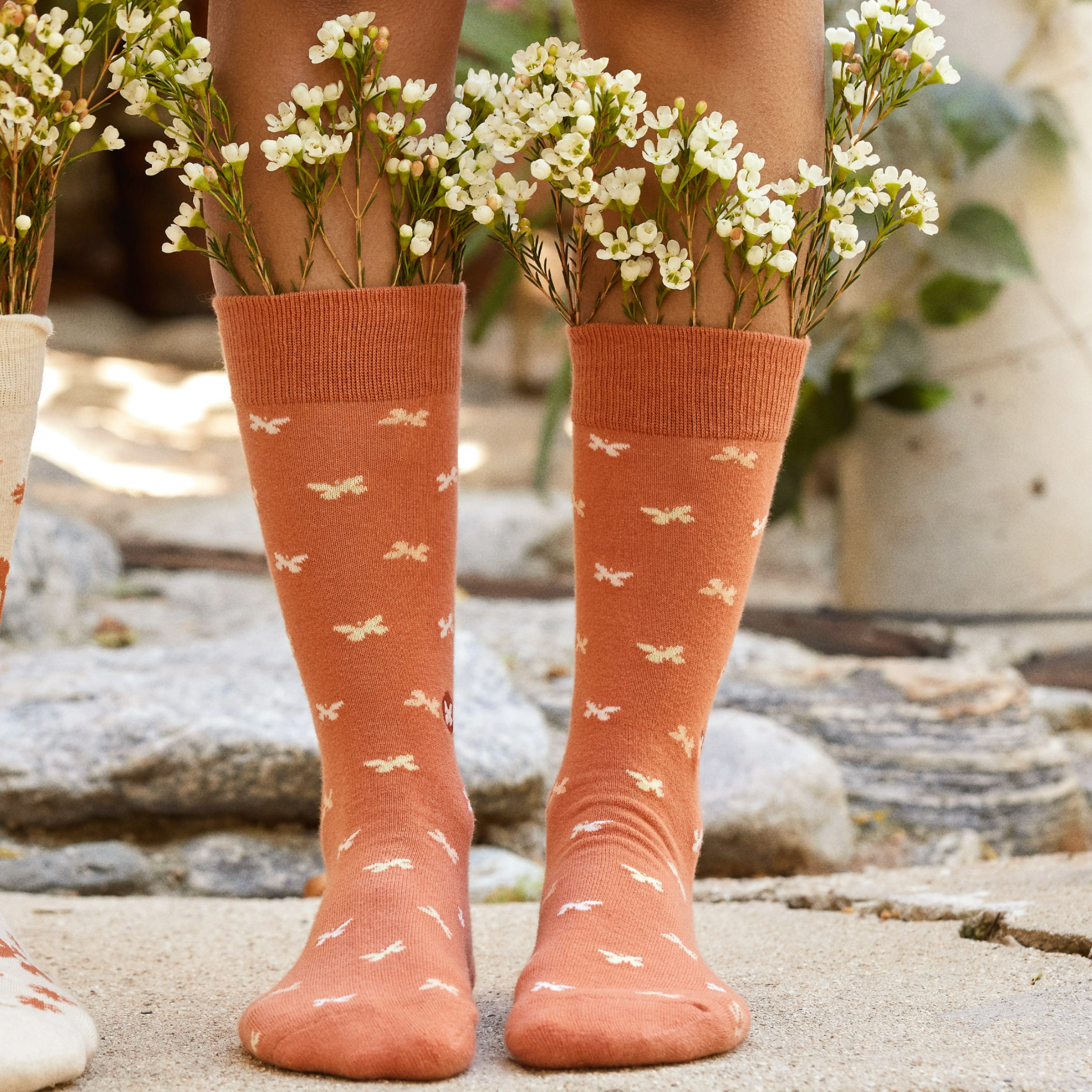Orange Empowerment Socks showcasing vibrant design for charity support