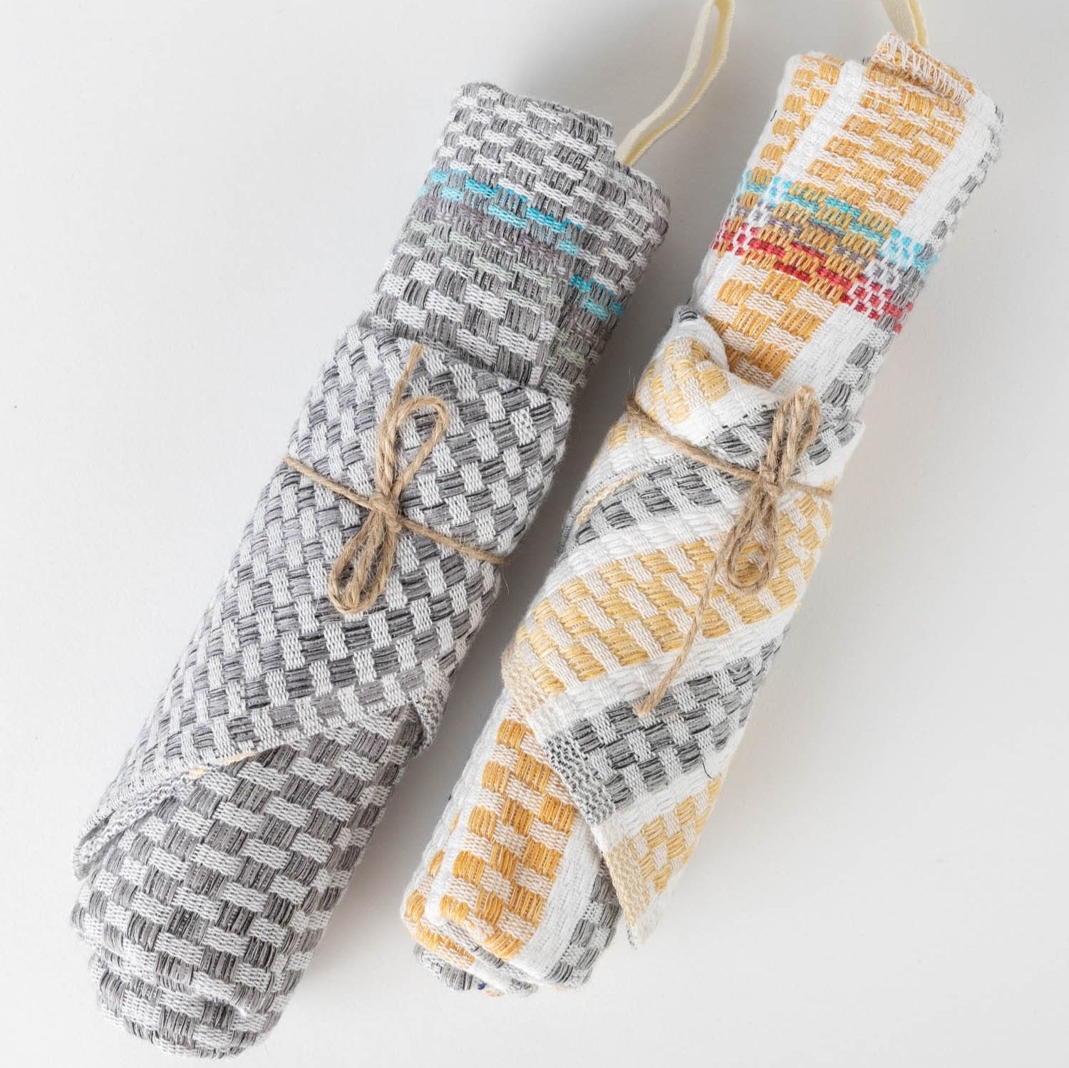Artisan kitchen towel draped over a pot, showcasing its absorbency and style.