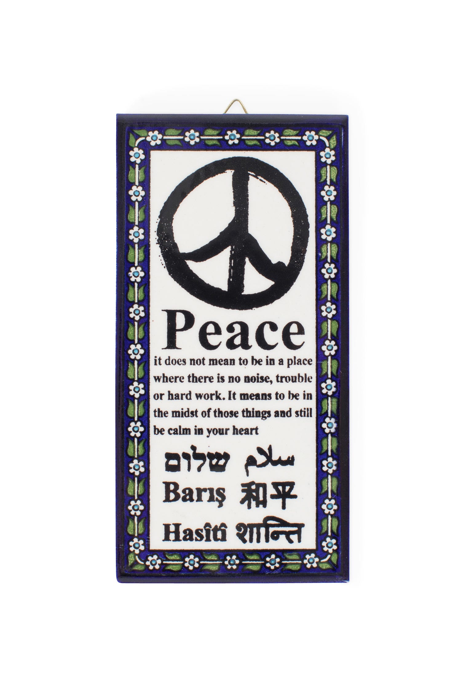 Close-up of hand-painted peace wall hanging for meditation with multilingual text.