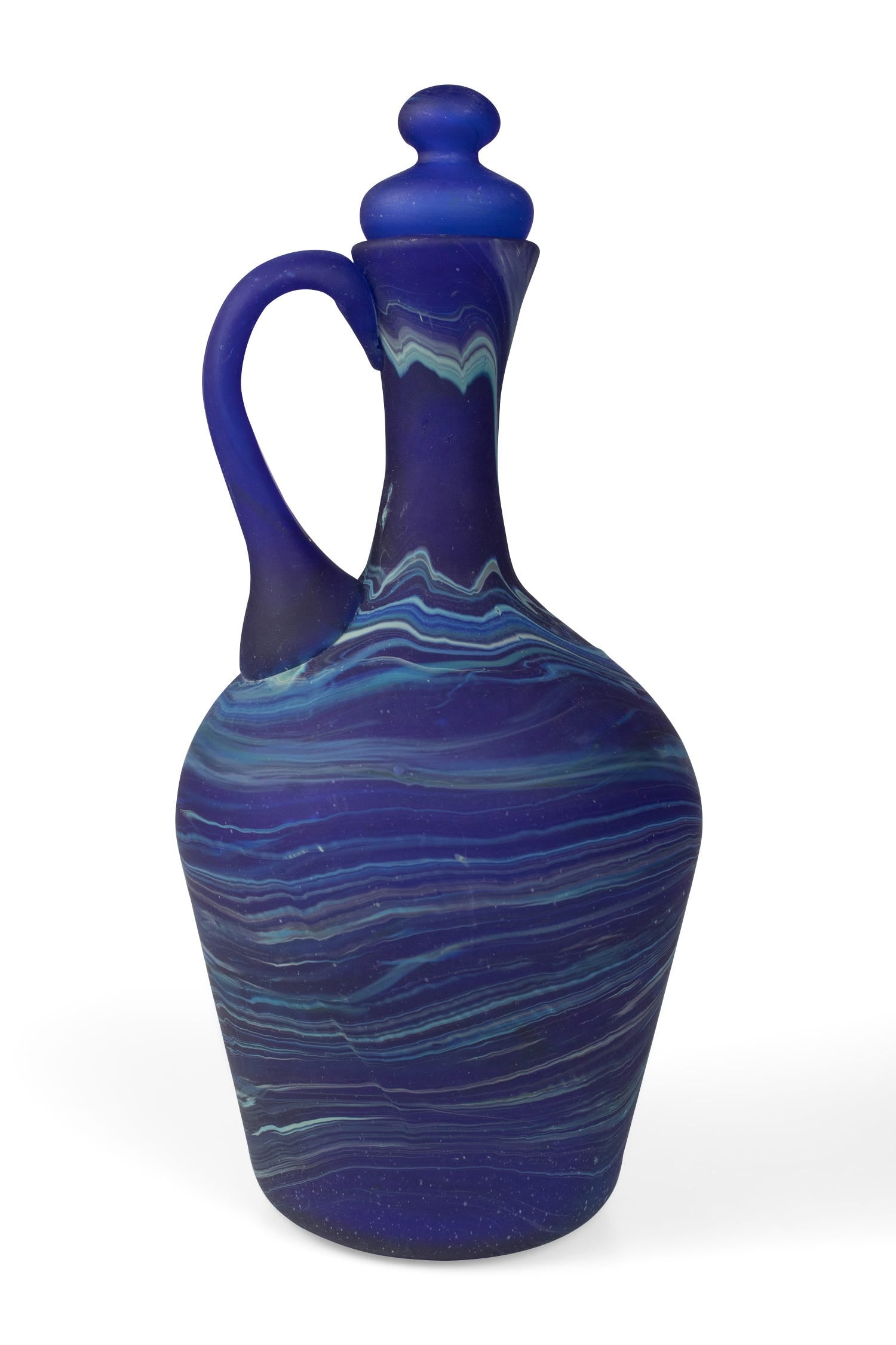 Close-up of artisan swirls on a blue decanter, showcasing craftsmanship and vibrant color