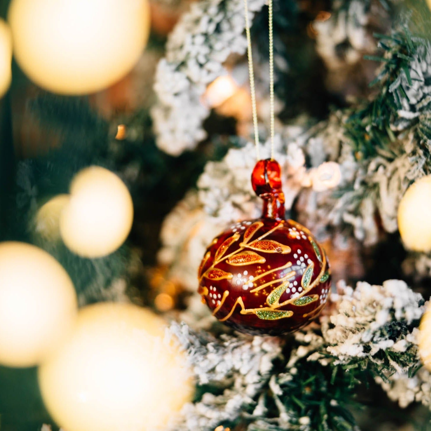 Natsheh handblown glass bulb ornament showcasing its unique swirl design in holiday setting