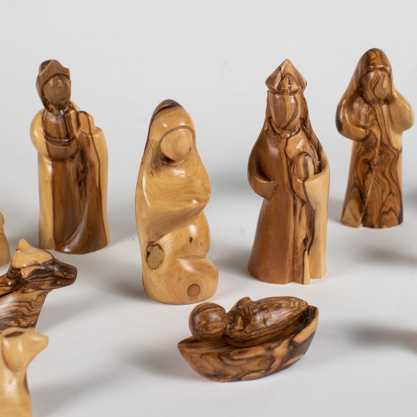 Close-up of intricately carved olive wood nativity figurines