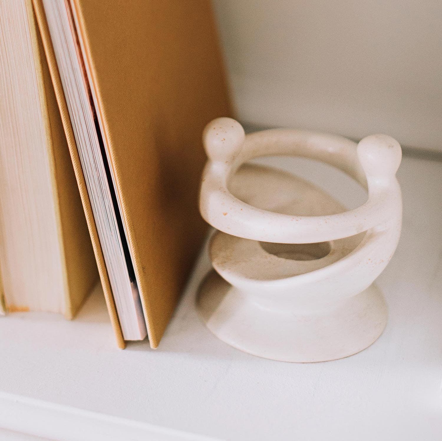 Kisii stone candleholder showcasing intricate carvings and a tea light candle, ideal for home decor.