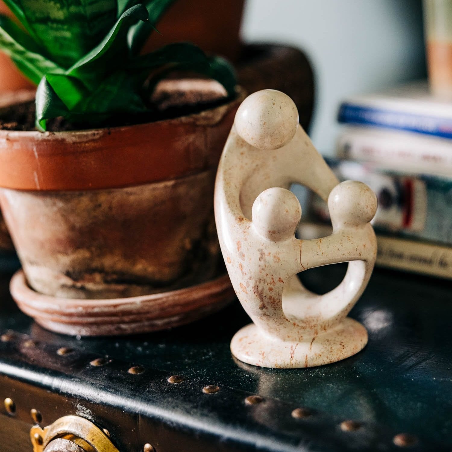 Close-up of the Embracing Love Sculpture showcasing intricate details of the Kisii stone craftsmanship.